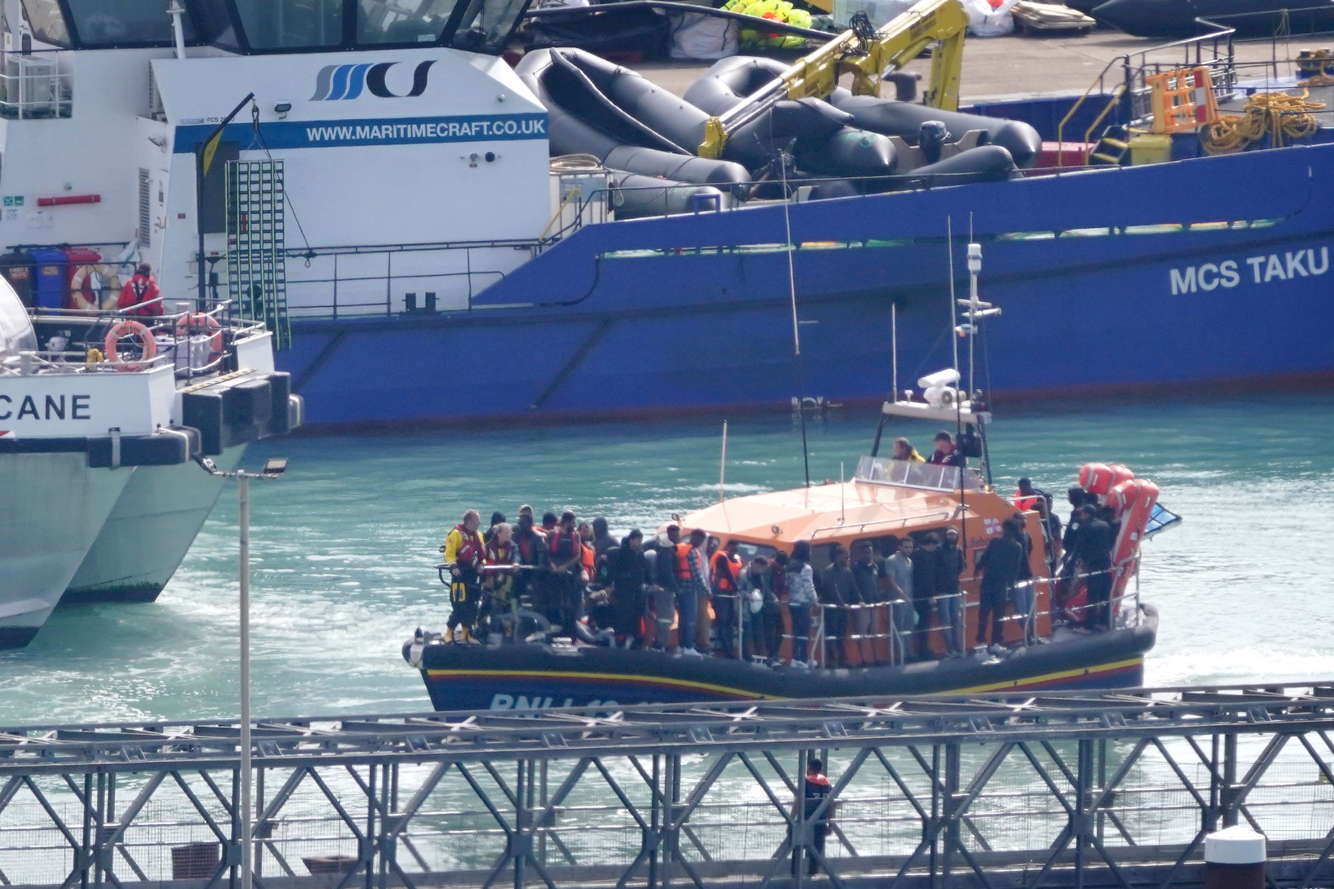 A group of people thought to be migrants are brought in to Dover onboard the RNLI Dungeness Lifeboat (PA)