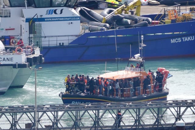 A group of people thought to be migrants are brought in to Dover onboard the RNLI Dungeness Lifeboat (PA)