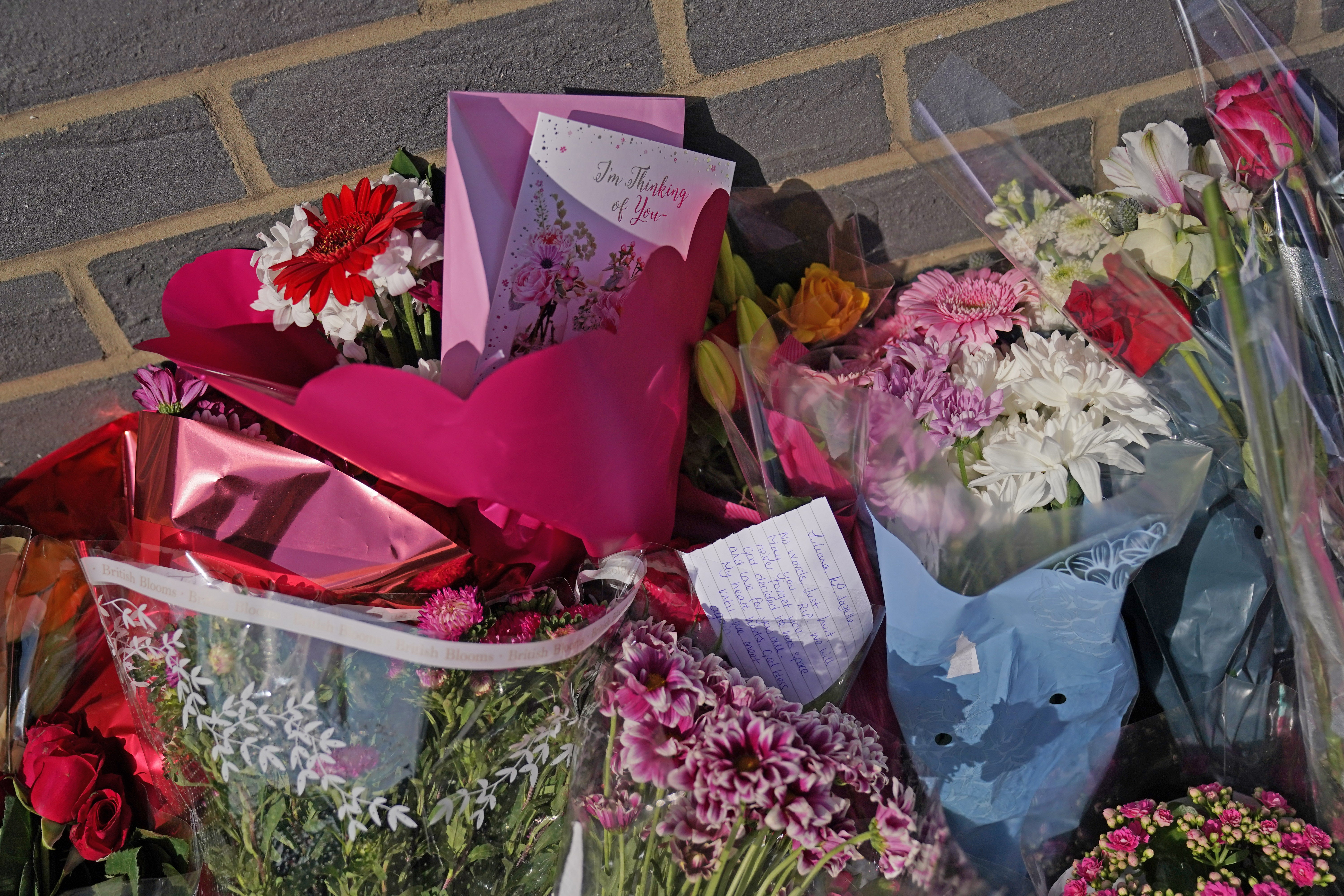 Floral tributes were left near the flat in Leabank, Luton