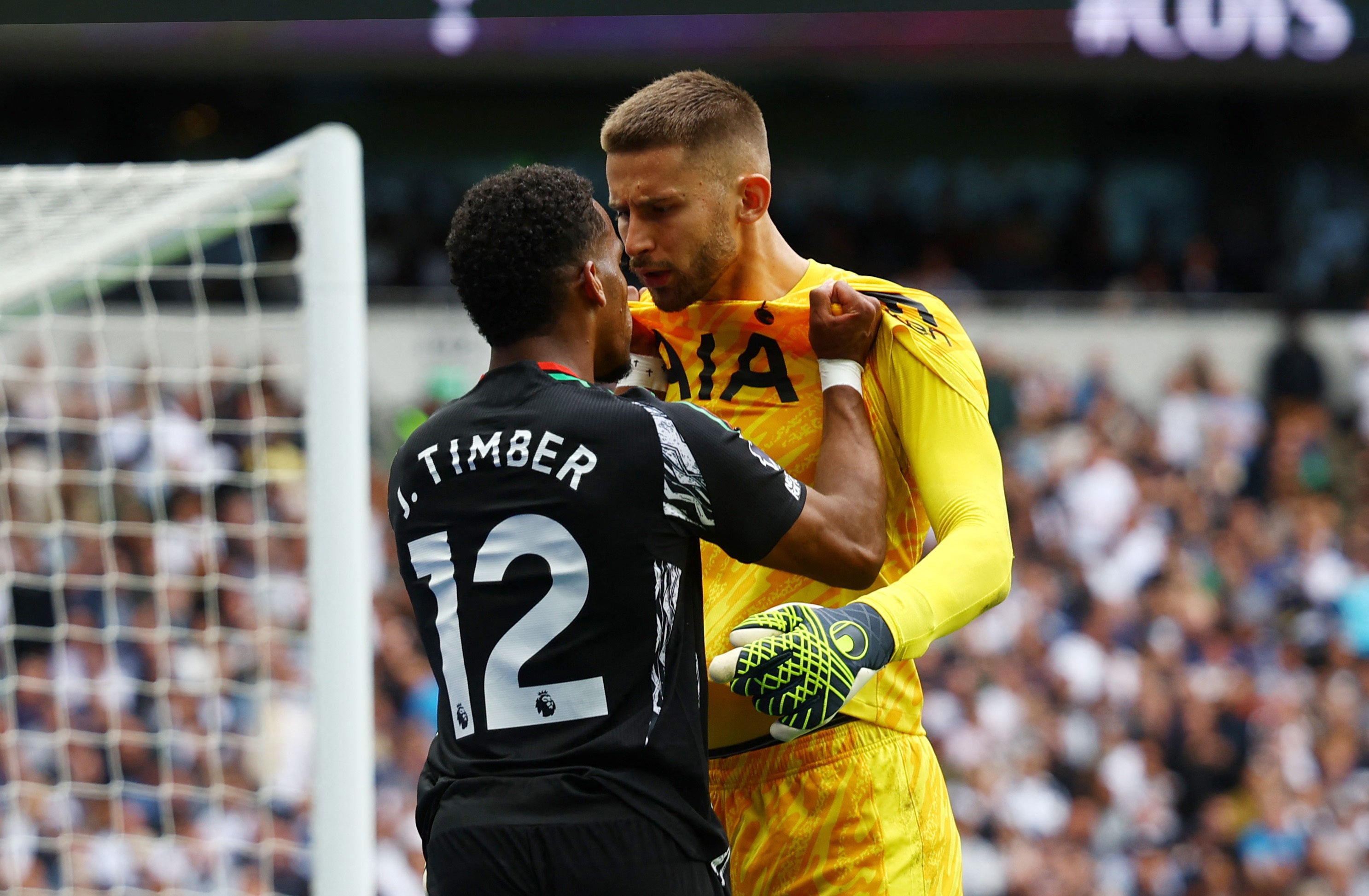 Arsenal’s Jurrien Timber squares up to Spurs goalkeeper Guglielmo Vicario