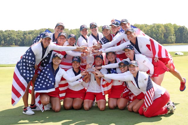 <p>Team USA celebrate with the Solheim Cup </p>