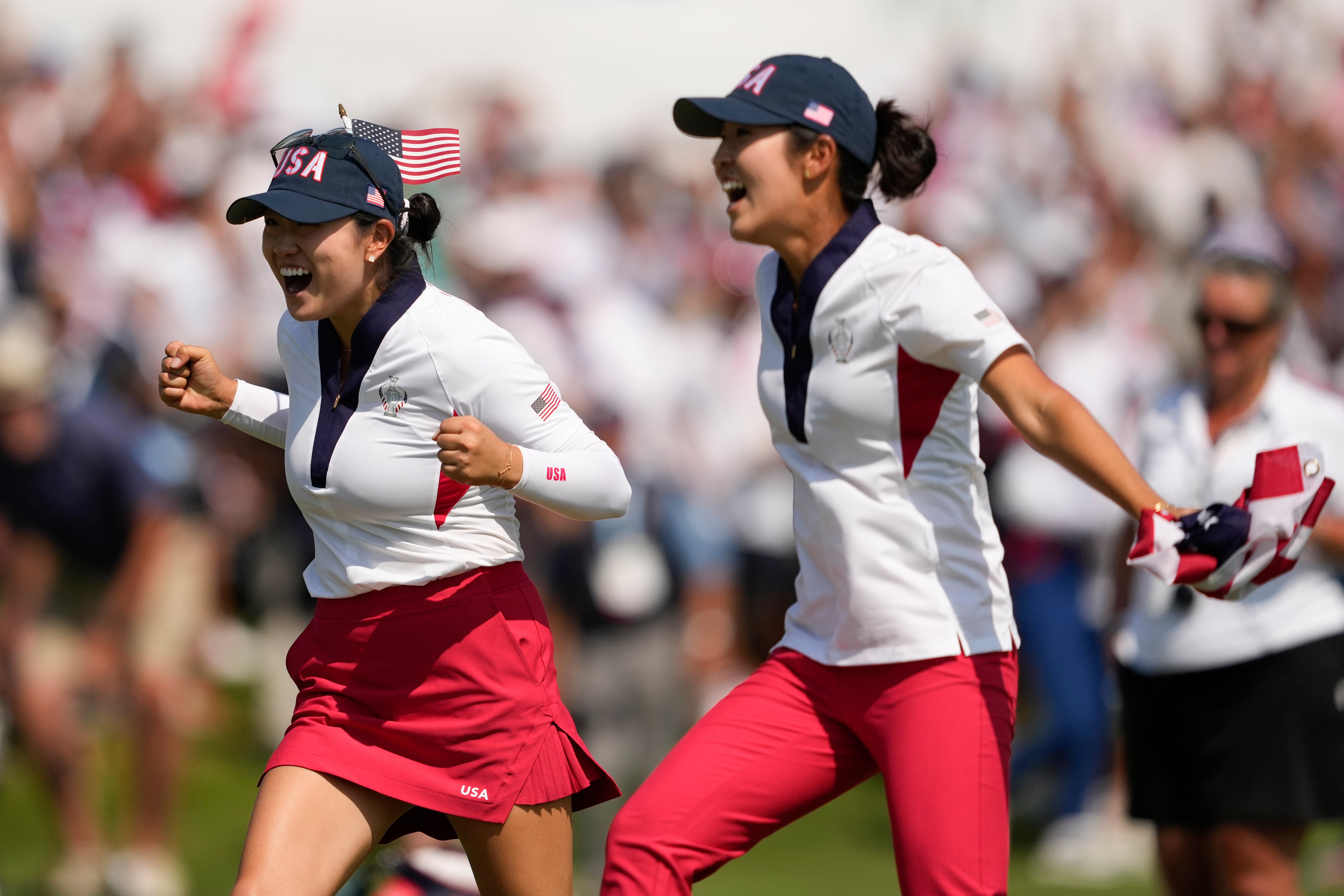 United States' Rose Zhang, left, and Andrea Lee celebrate after a putt by Lilia Vu gave their team the win