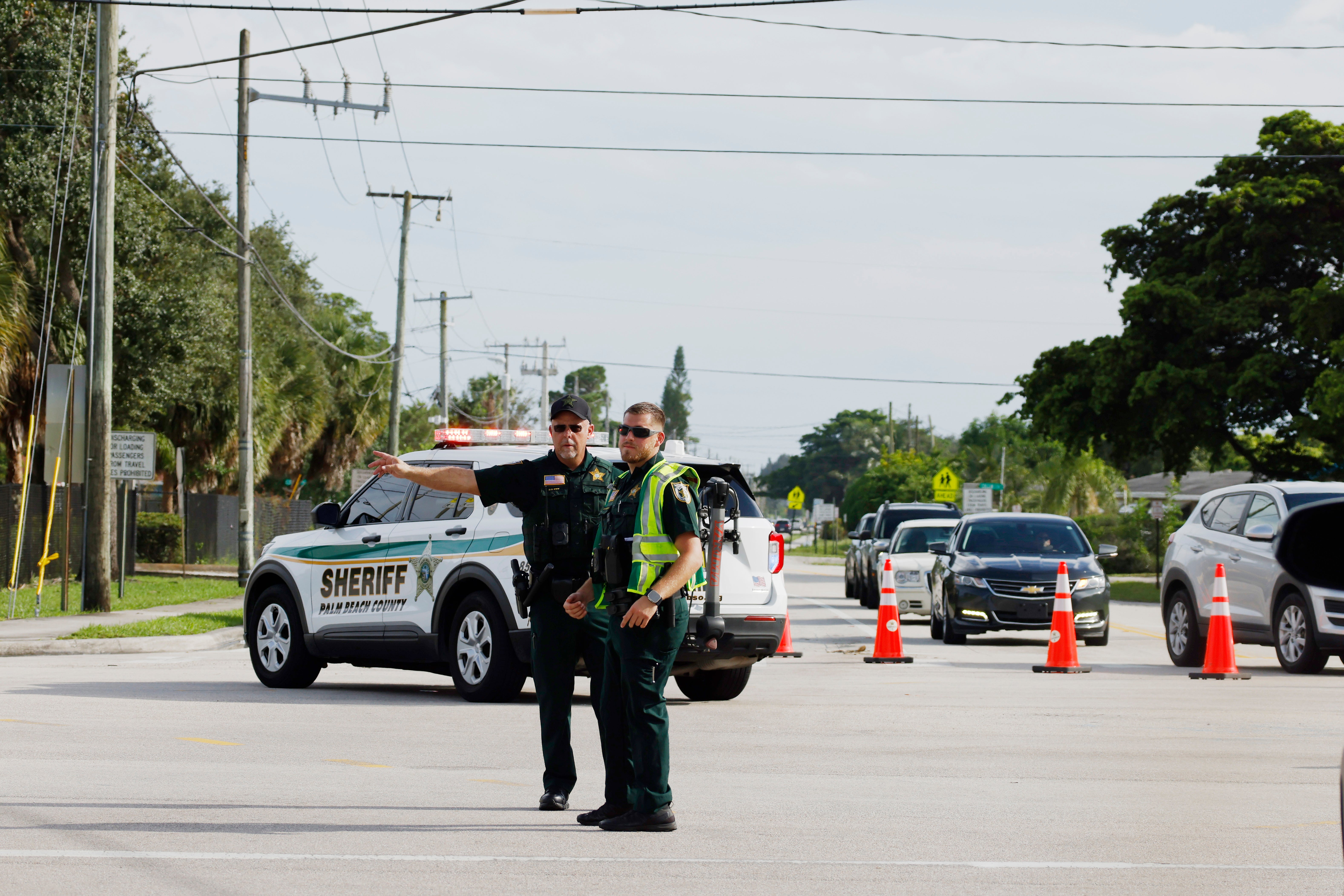 Police officers direct traffic near Trump International Golf Club after the apparent assassination attempt of Republican presidential nominee former President Donald Trump in West Palm Beach, Fla., Sunday, Sept. 15, 2024