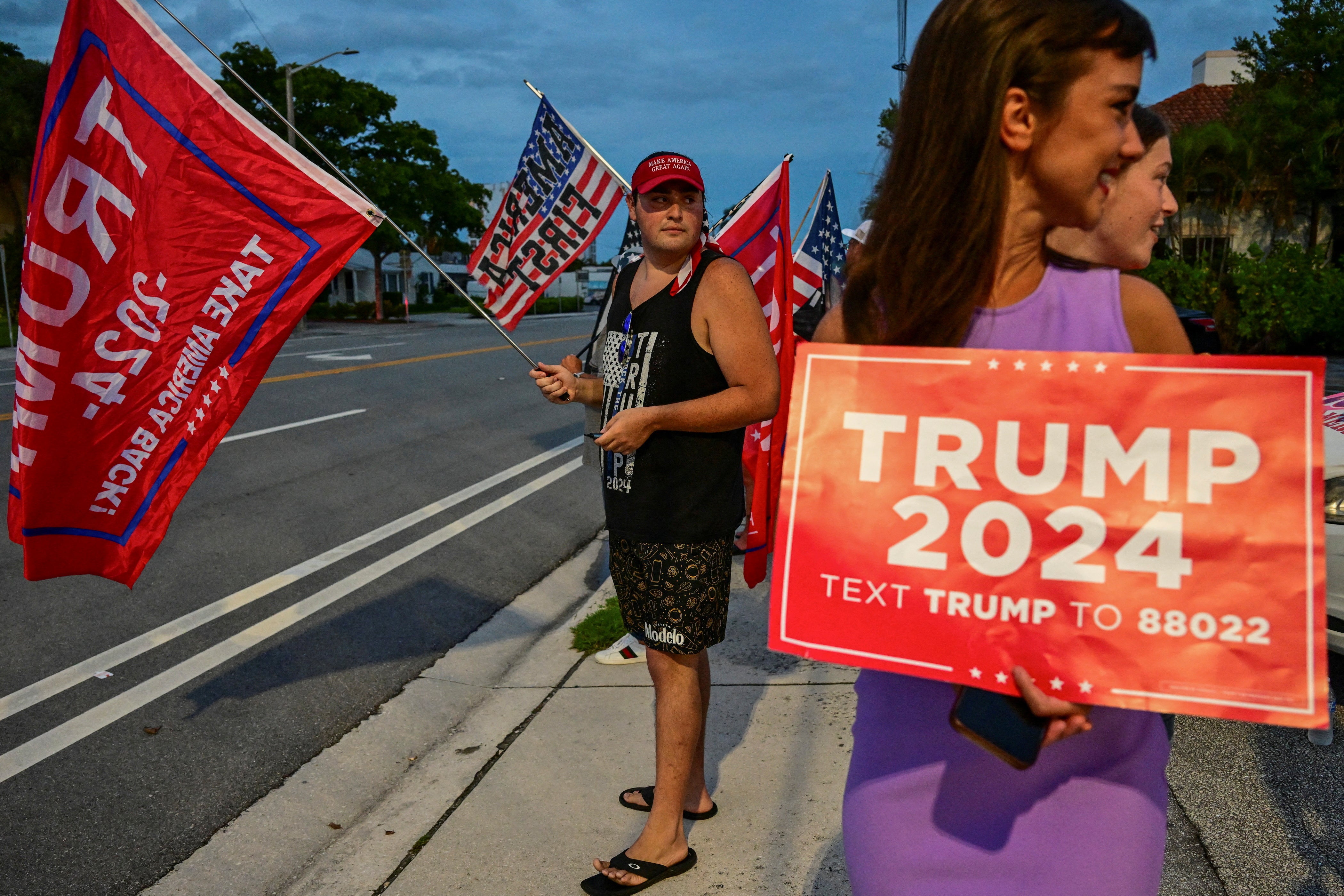 Supporters of Republican presidential nominee and former U.S. President Donald Trump gather around Mar-A-Lago, after he returned from Trump International Golf Club