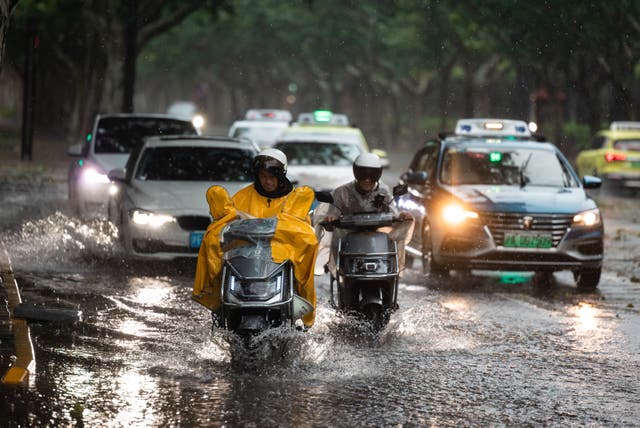 <p>People drive on a flooded road after Bebinca hit Shanghai, China, on 16 September 2024 </p>