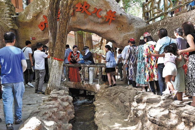 <p>Visitors line up to enter a scenic spot with the Karez system in Turpan, Xinjiang Uygur autonomous region, in June</p>