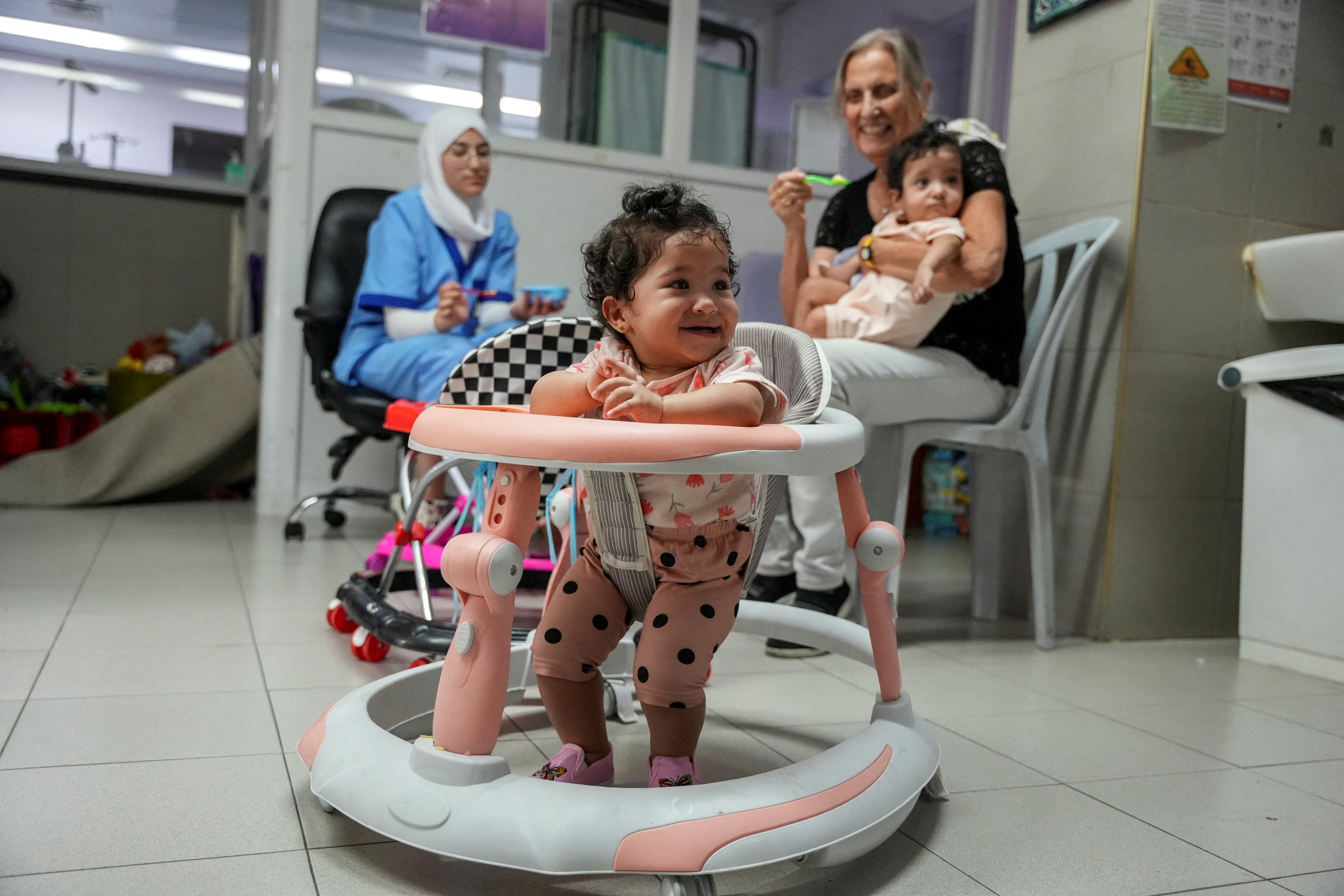 Two girls from the Palestinian triplets of al-Bayouk family, born prematurely and separated from their mother who had to leave them at hospital in Jerusalem to recover as she had to return to Gaza