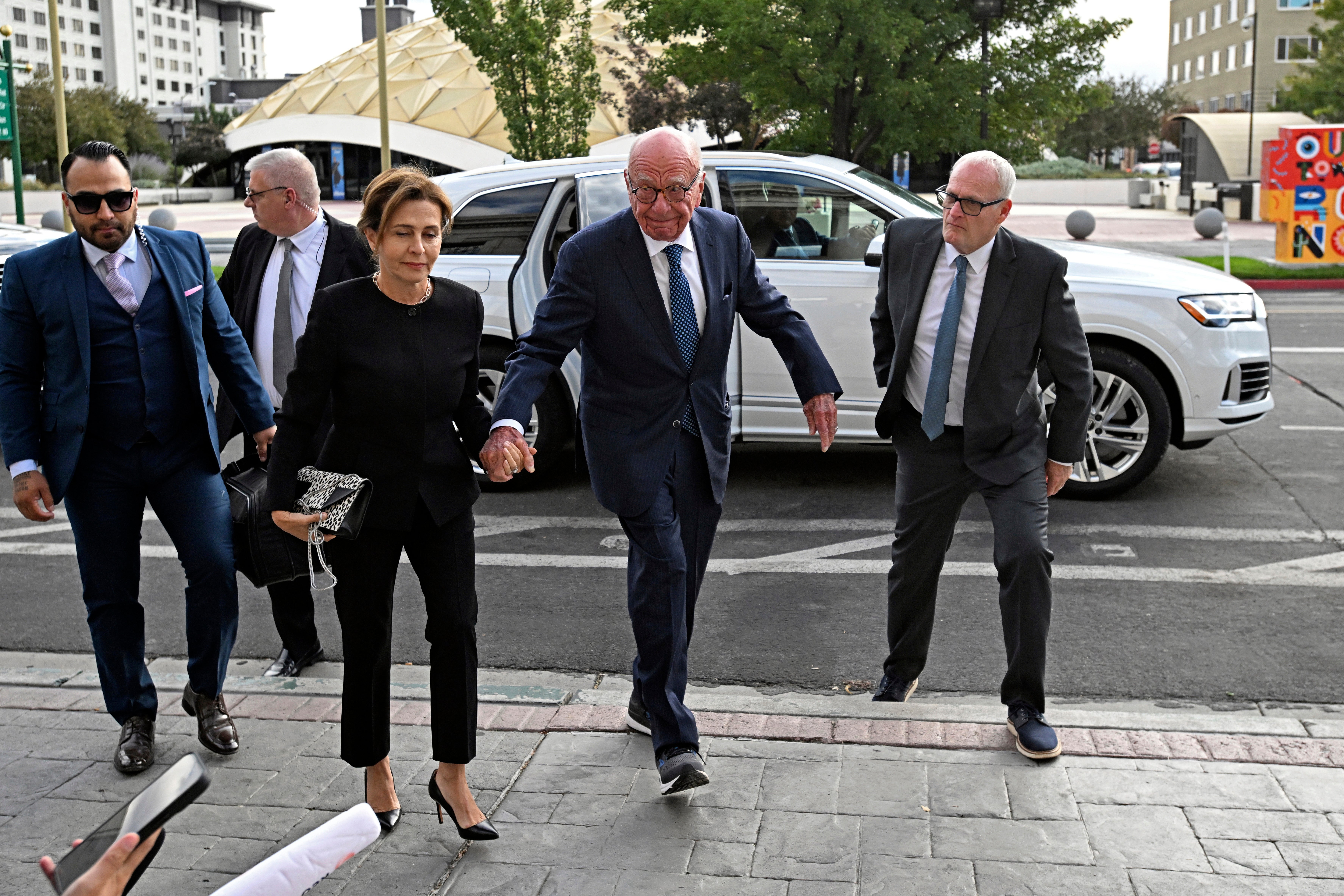 Rupert Murdoch, center, and his wife Elena Zhukova Murdoch arrive at the Second Judicial District Court in Reno,