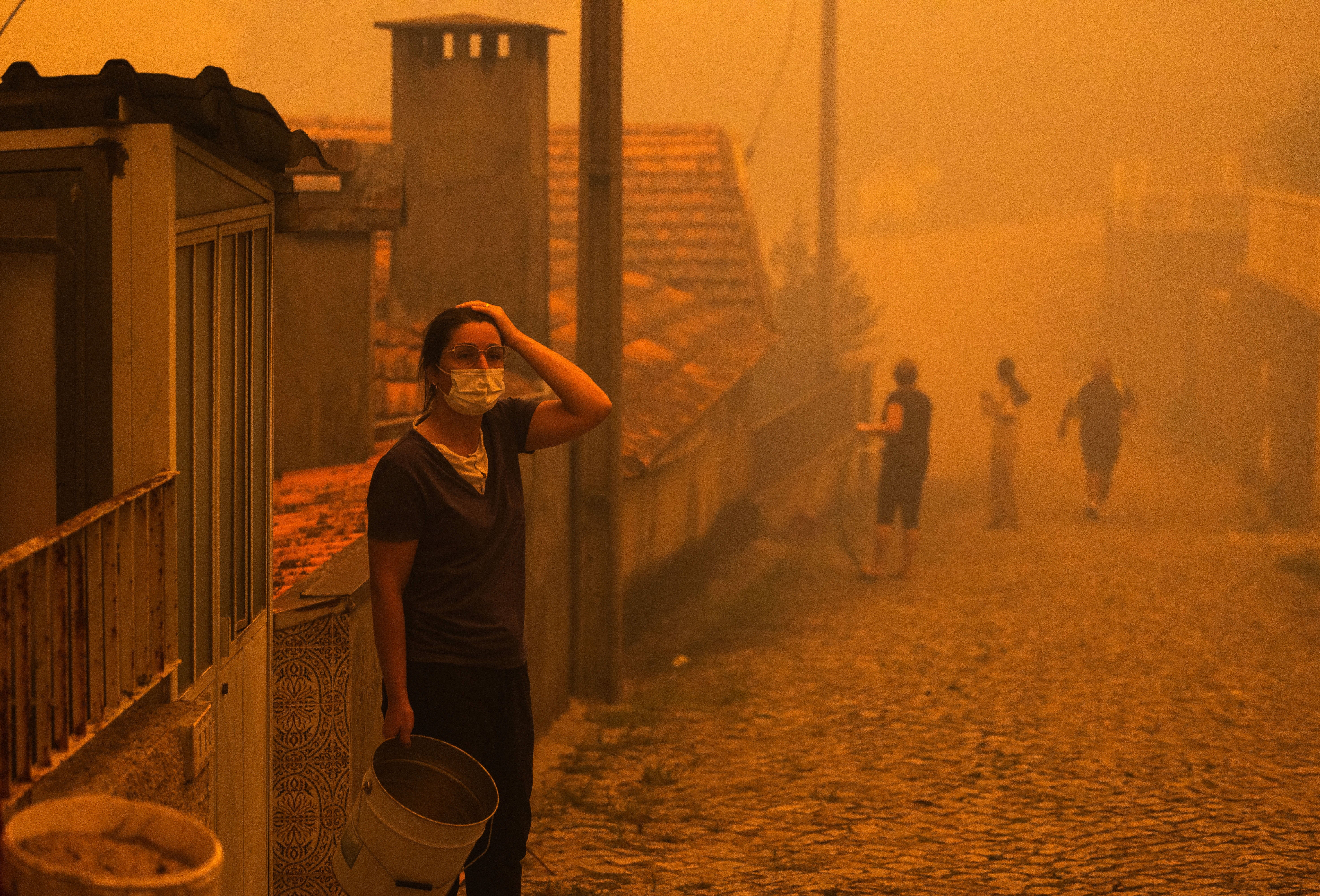 A woman next her home in Covelo, Gondomar, northern Portugal