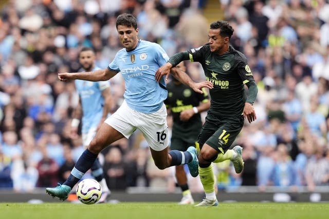 <p>Rodri (left) and Brentford’s Fabio Carvalho battle for the ball during Manchester City’s 2-1 win </p>