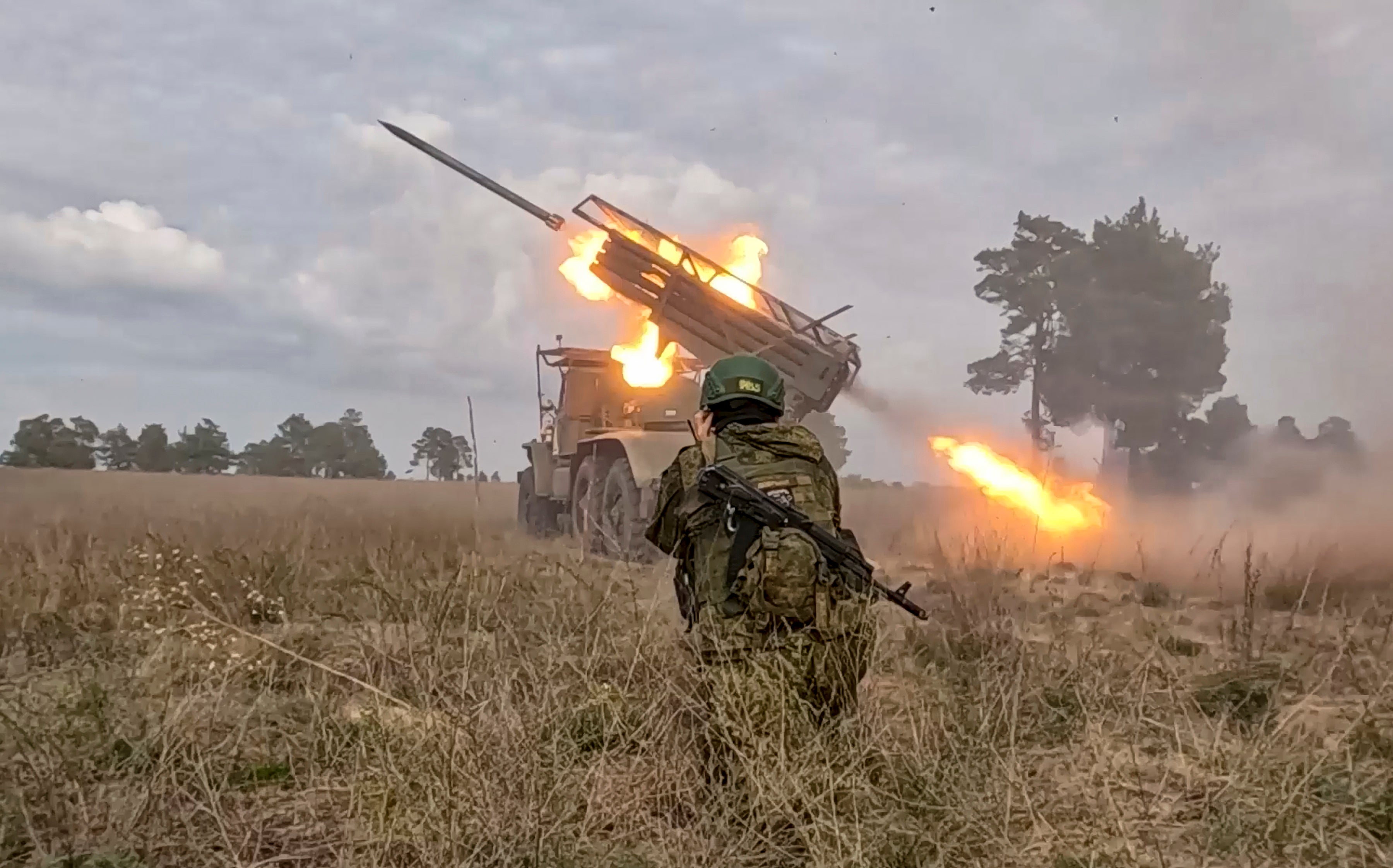 A Russian BM-21 Grad, a self-propelled 122 mm multiple rocket launcher, fires towards Ukrainian positions at an undisclosed location in Russia