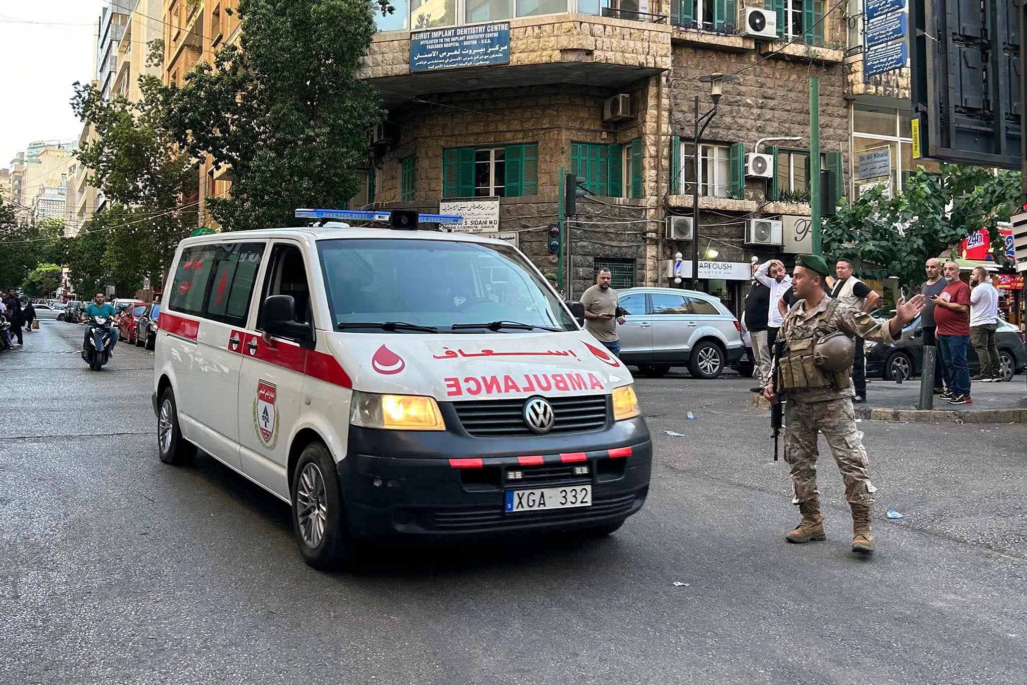 An ambulance rushes wounded people to a hospital in Beirut on September after the blasts