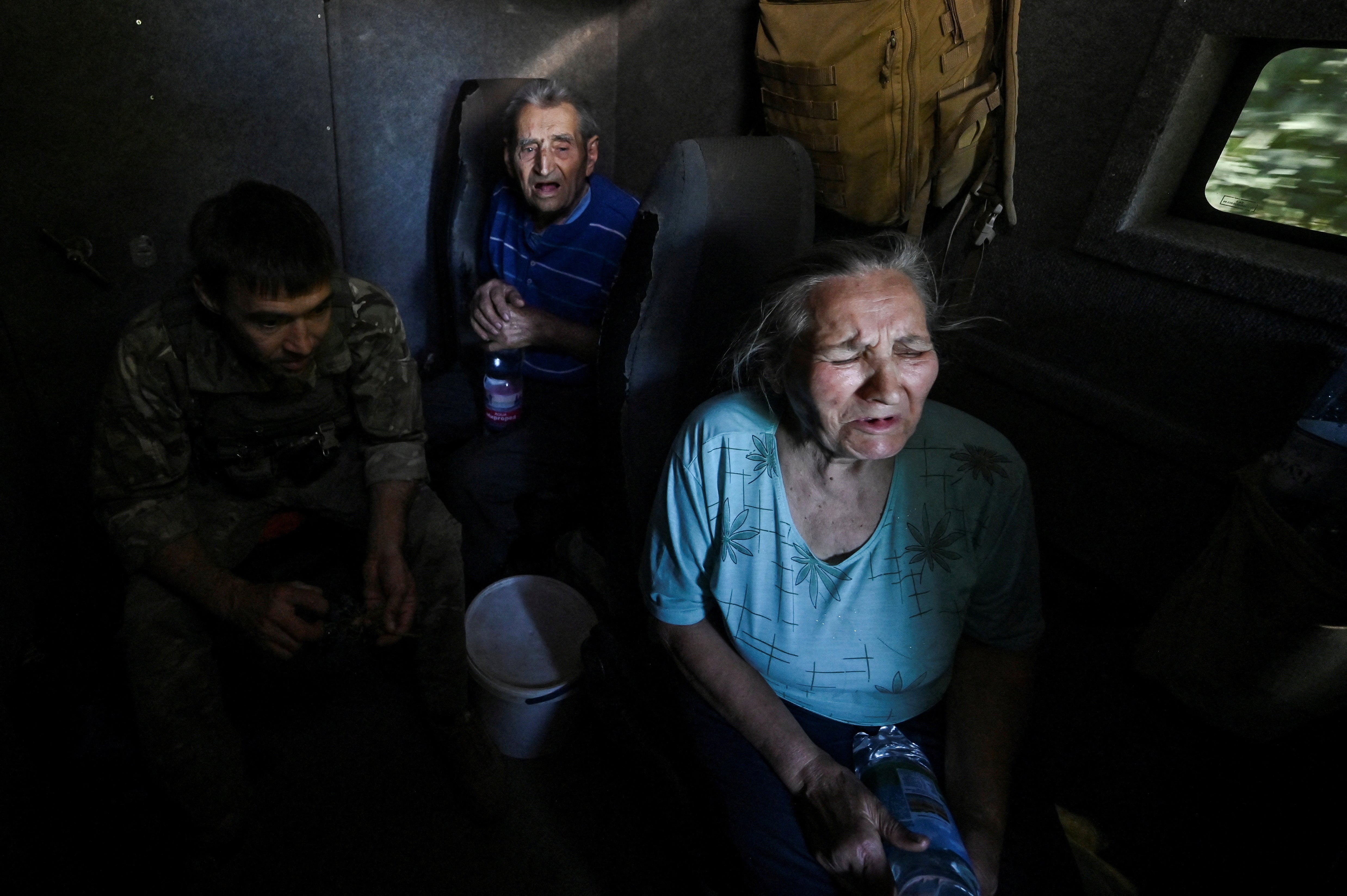 Civilians react during their evacuation from the outskirts of Kurakhove town