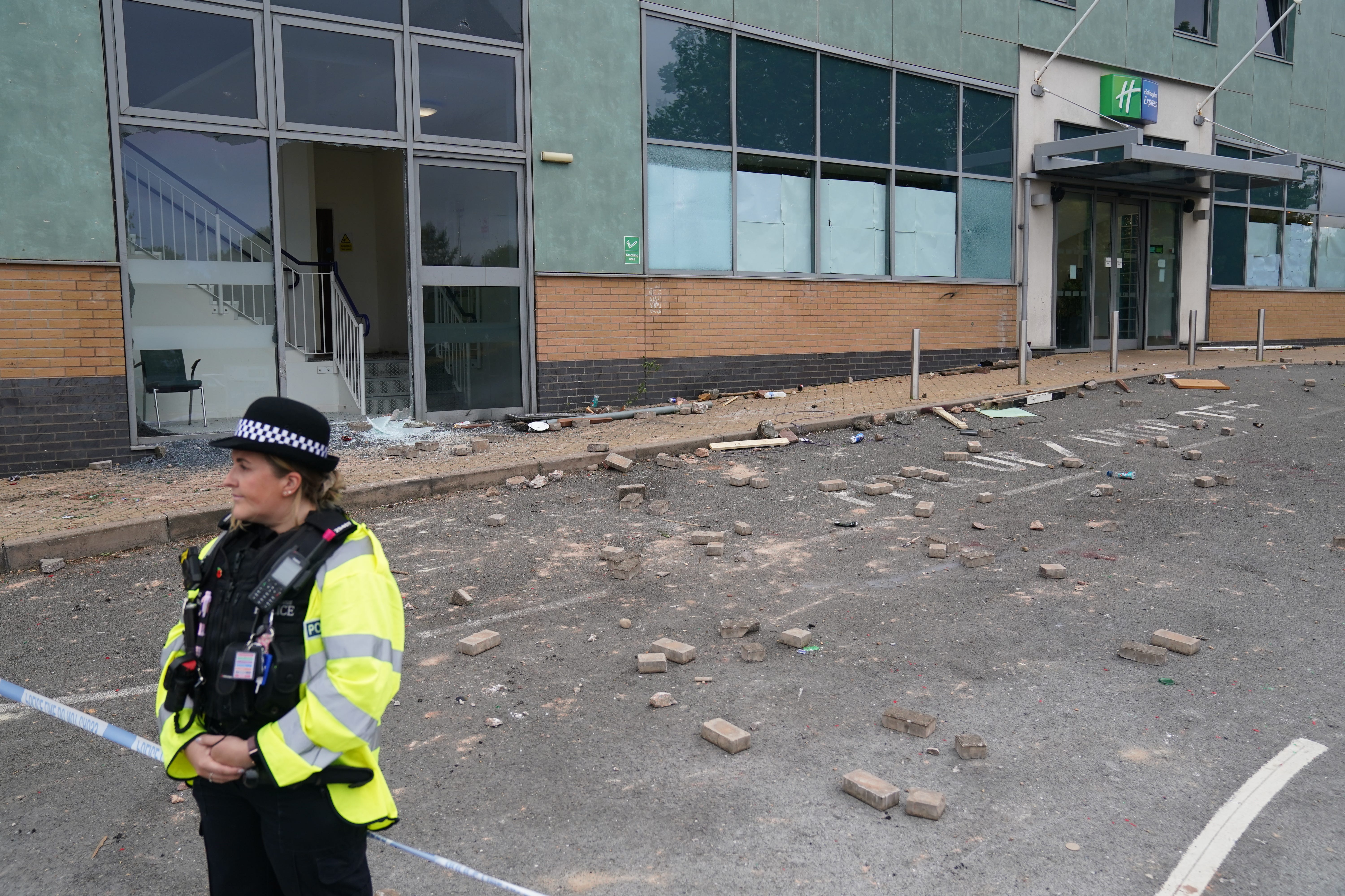 Police at the Holiday Inn Express in Tamworth, Staffordshire, after a mob attacked it (Jacob King/PA)