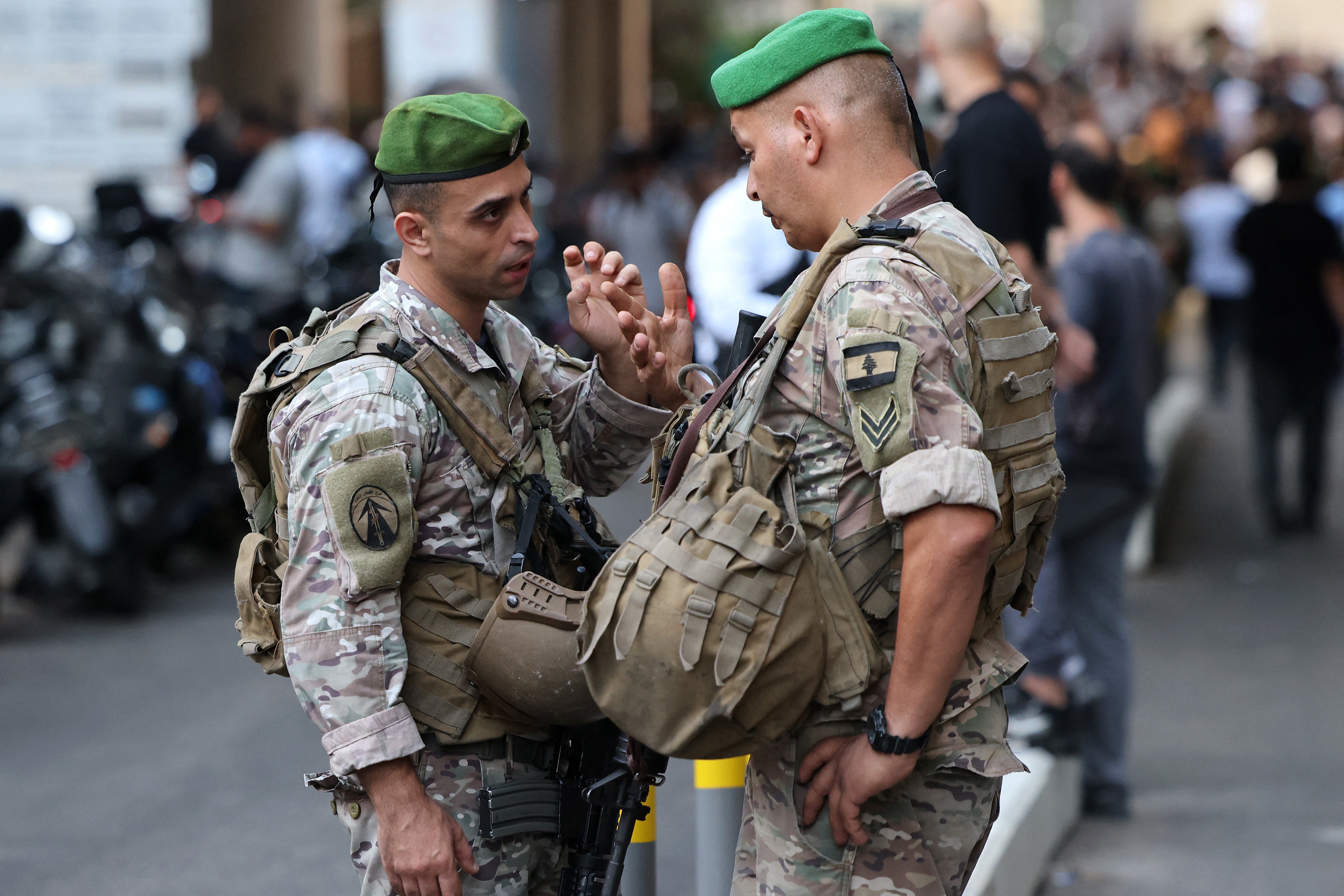 Lebanese army soldiers stand guard at the entrance of a hospital (background) in Beirut