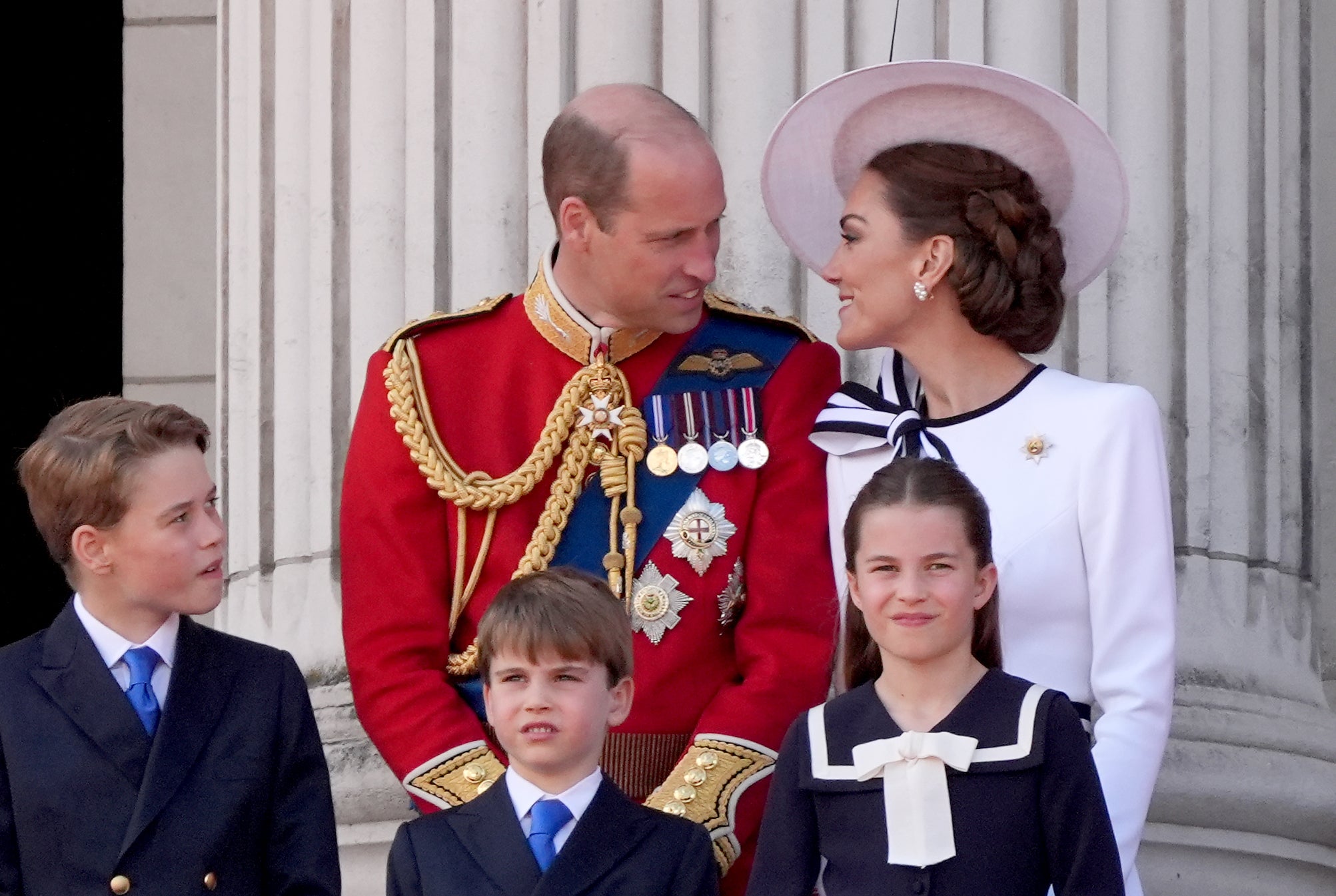 The Prince and Princess of Wales with their children Prince George, Prince Louis and Princess Charlotte on the balcony of Buckingham Palace after the flag parade (Gareth Fuller/PA)