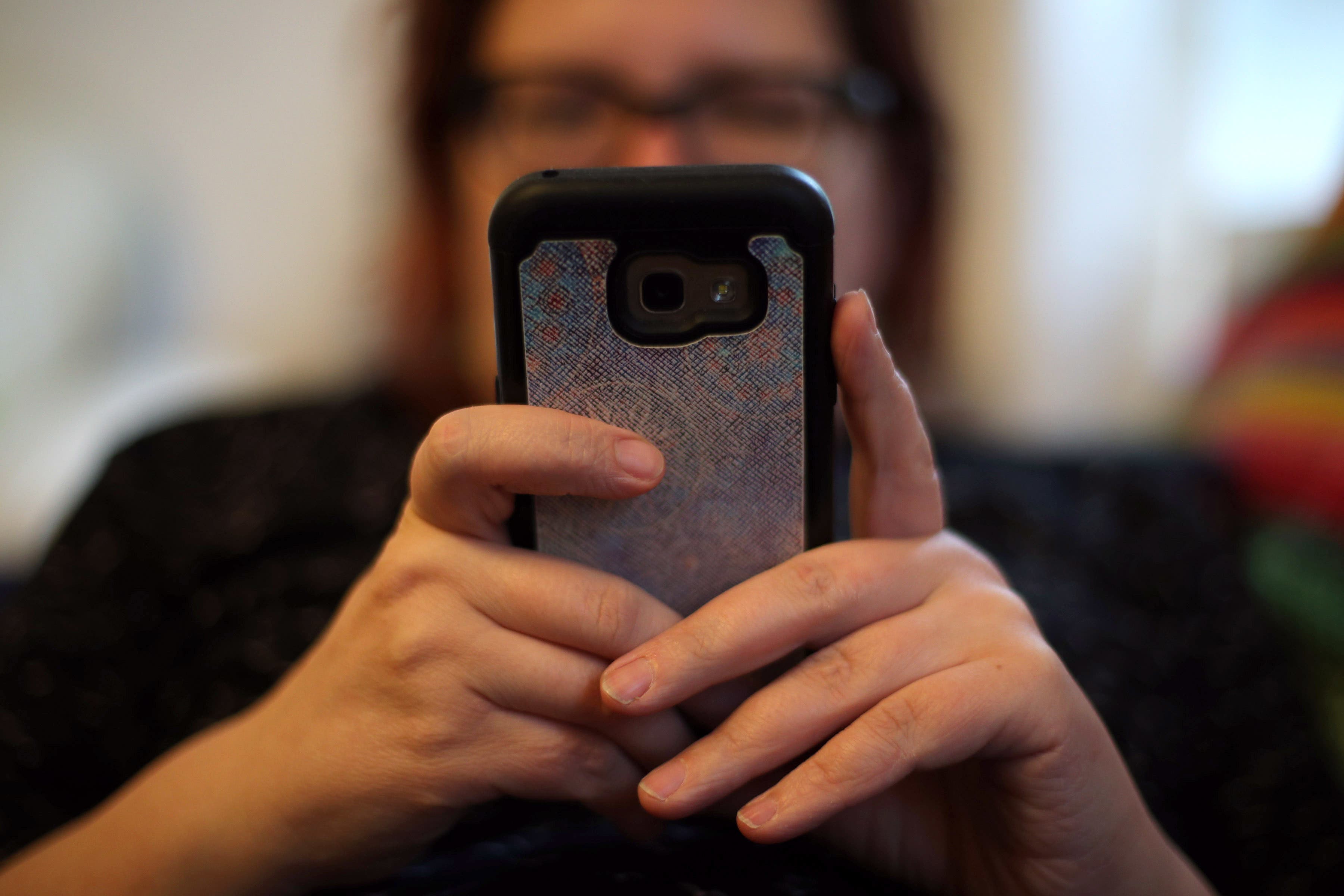 A woman using online banking on her mobile phone