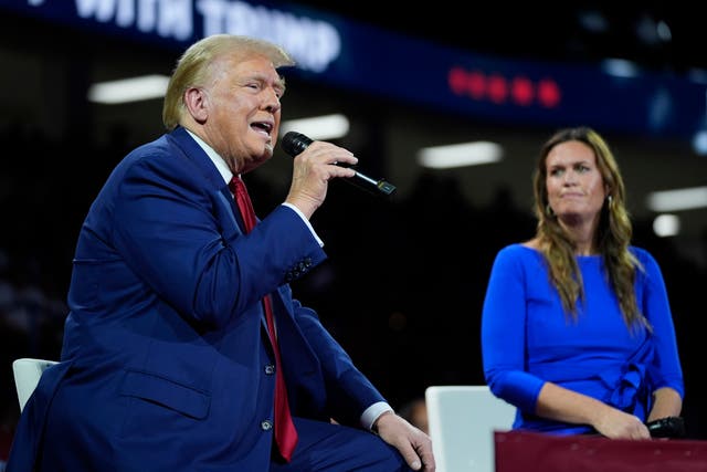 <p>Republican presidential candidate Donald Trump on stage with Arkansas Governor Sarah Huckabee Sanders during a town hall event at the Dort Financial Center in Flint, Michigan, on Tuesday September 18 2024. He spoke about the latest attempt on his life </p>