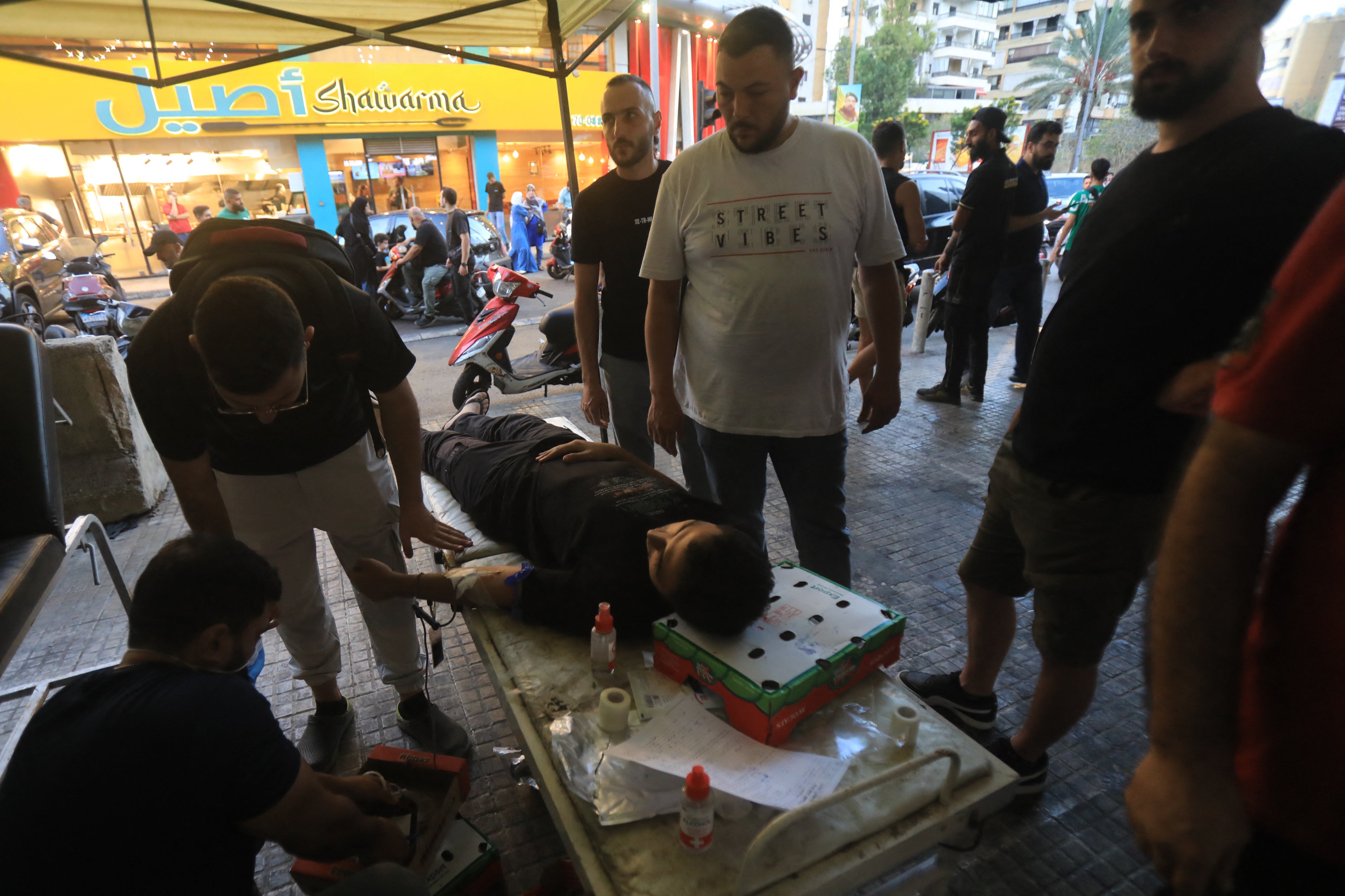 A man donates blood under a tent in Beirut’s southern suburb following the pager explosions on 17 September 2024