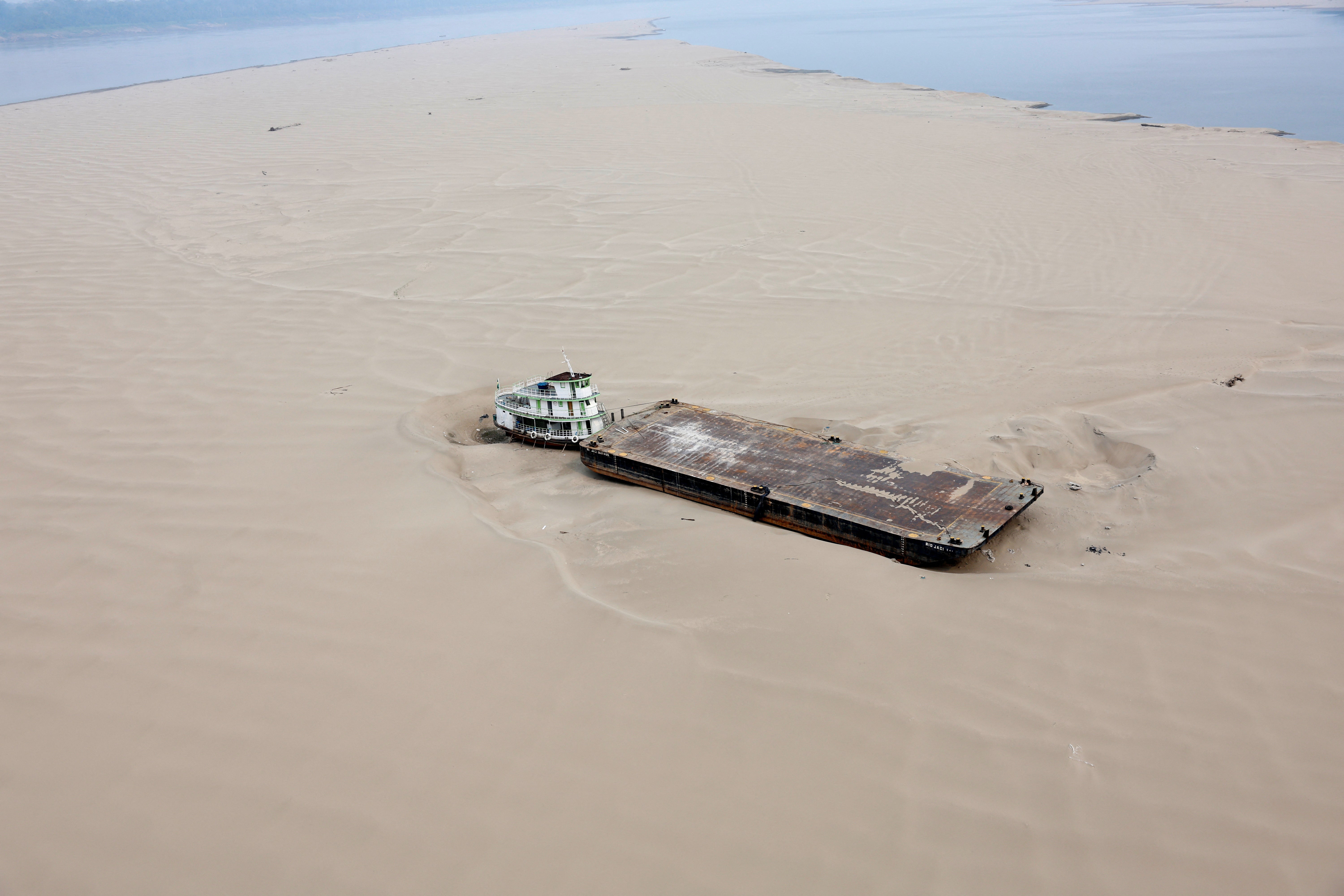 A hopper barge is seen stranded in a sandbank at Brazil’s Solimoes River on Tuesday. The country is experiencing its worst drought since measurements began, with rivers at their lowest levels in decades.