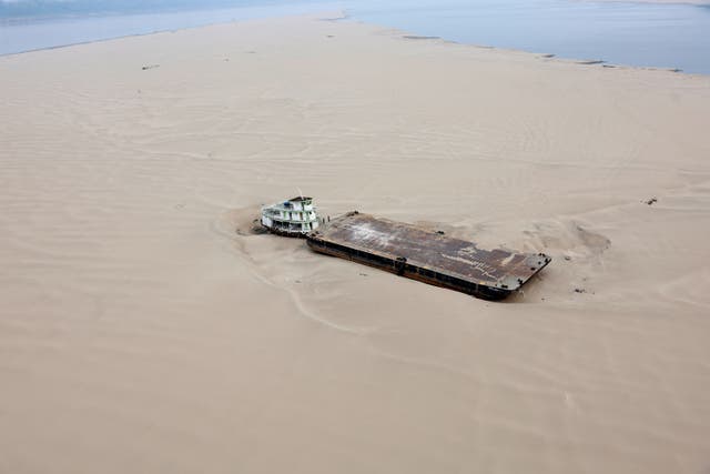 <p>A hopper barge stranded in a sandbank at Brazil’s Solimoes River on Tuesday. The country is experiencing  its worst drought since measurements began, with rivers at their lowest levels in decades. </p>