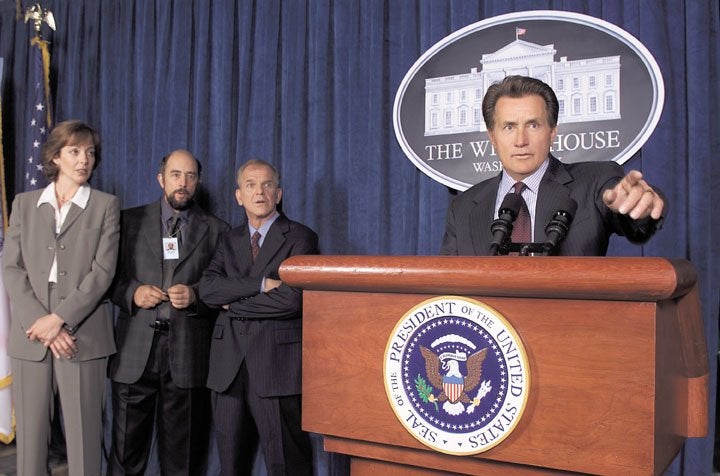 Next question: CJ (Janney), Toby (Schiff), Leo (Spencer) and President Bartlet (Sheen) before the White House press corps