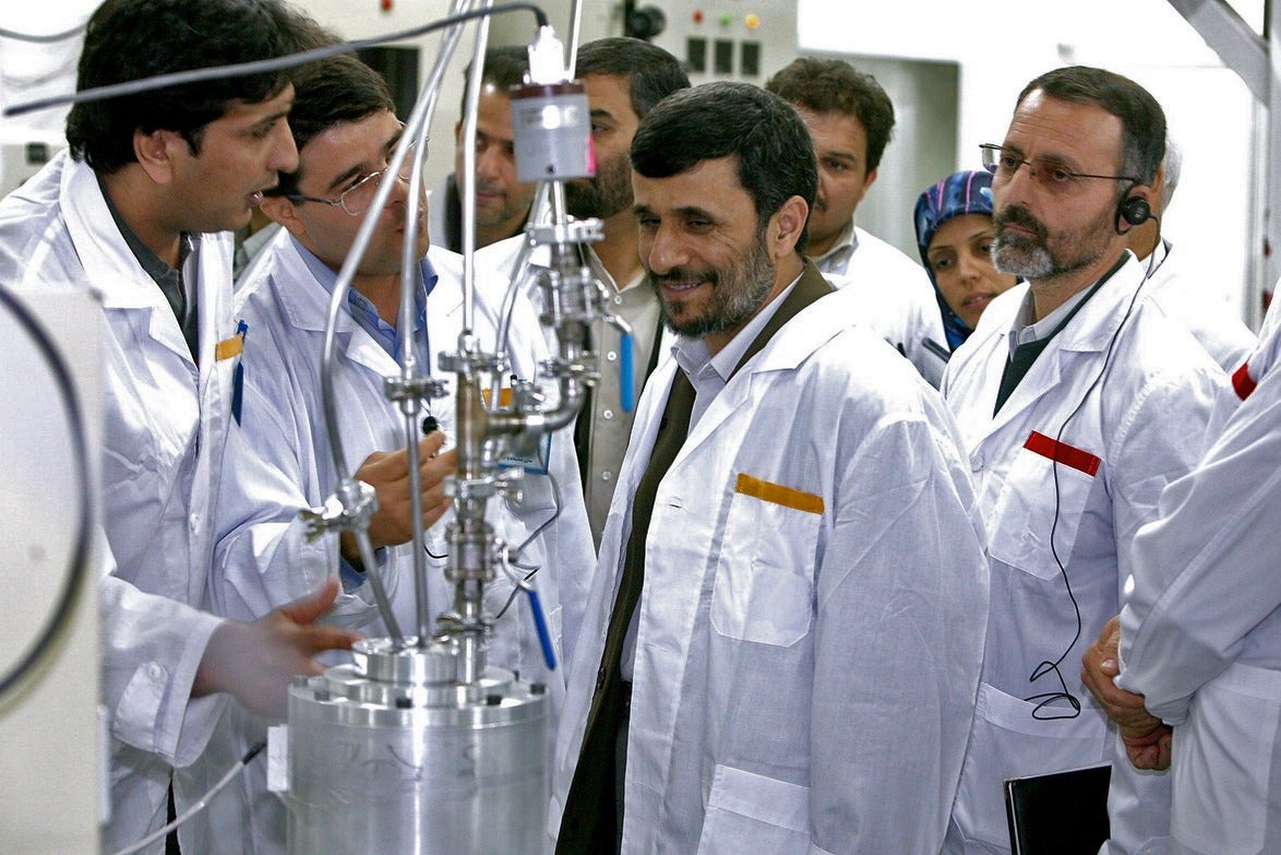 Former president Mahmoud Ahmadinejad, center, was reported killed in the airstrikes