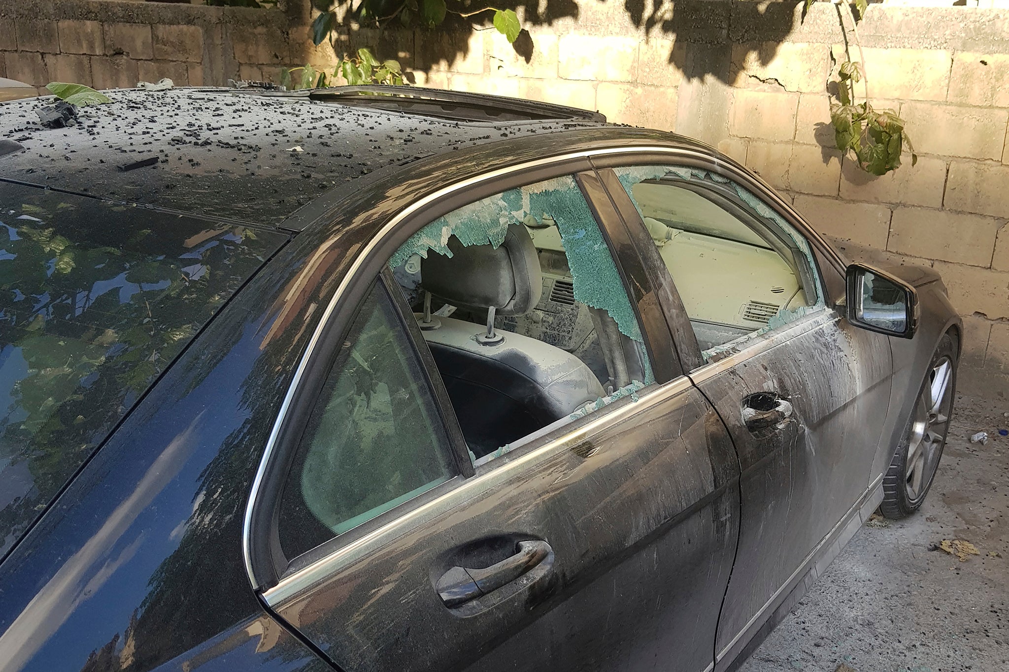 A partly damaged car after what is believed to be the result of a walkie-talkie exploding inside it