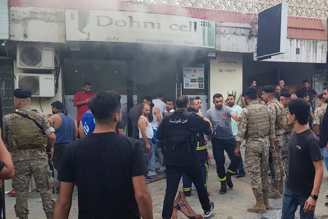 <p>Lebanese soldiers gather outside a phone shop on Wednesday after what was believed to have been an explosion due to a walkie-talkie within</p>