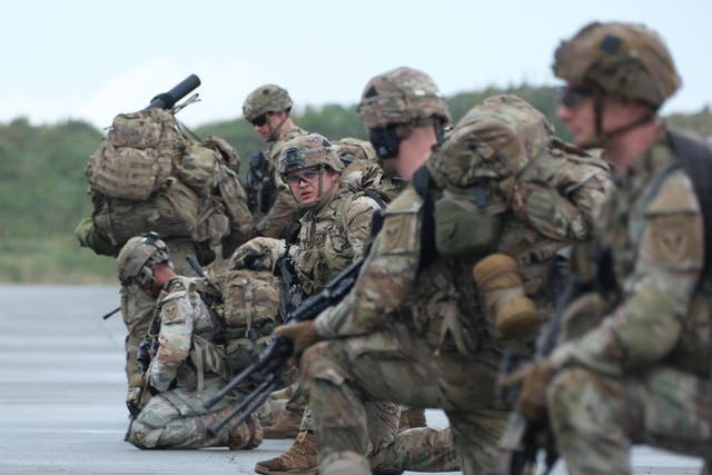 <p>Members of the U.S. Army Task Force Geronimo kneel during an operation deploying soldiers, radar, and rocket-launchers to Shemya Island, Alaska, amid increase Russian military activity.</p>