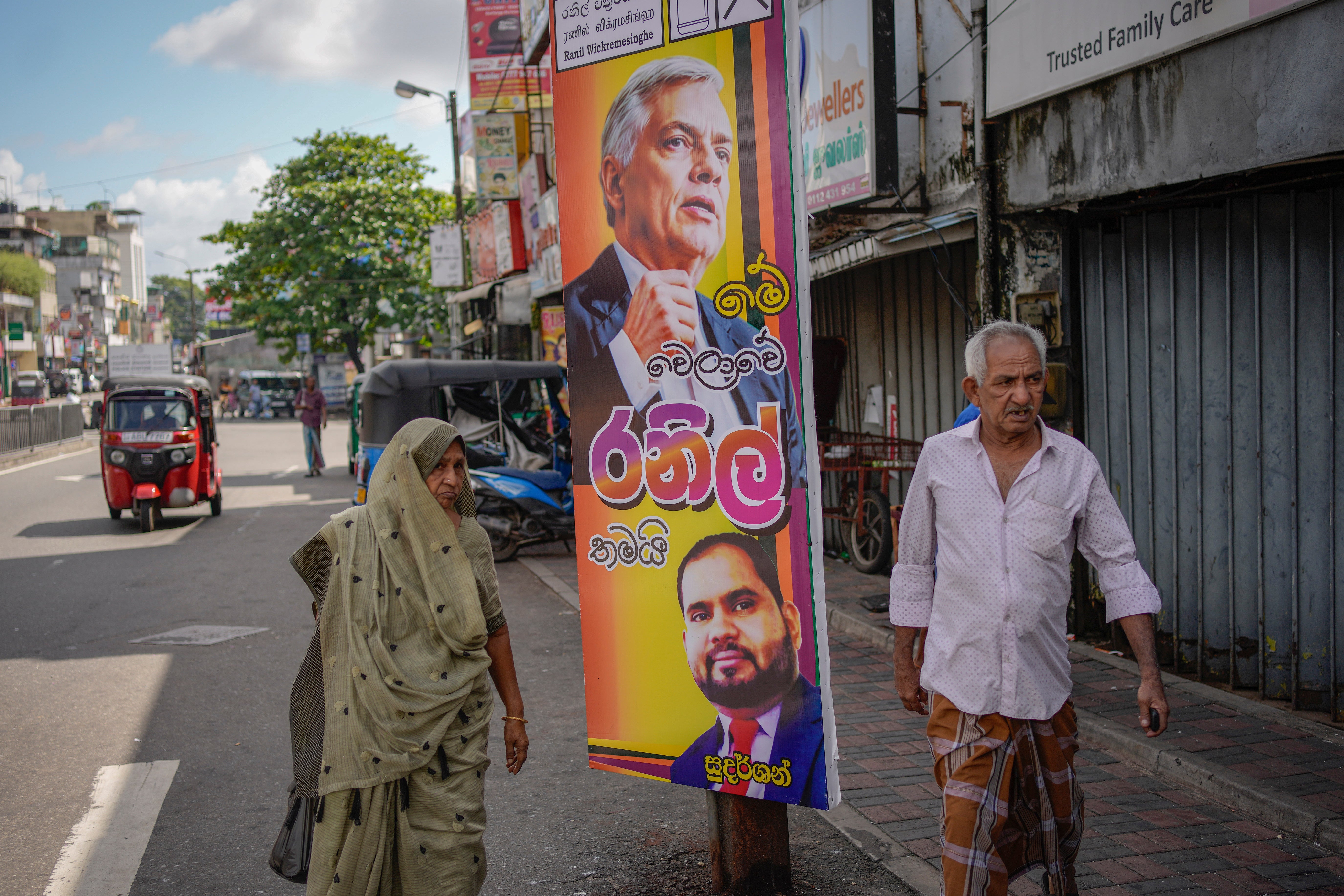 A mates  walks past   an predetermination  poster showing a representation    of Sri Lankan president   Ranil Wickremesinghe successful  Colombo