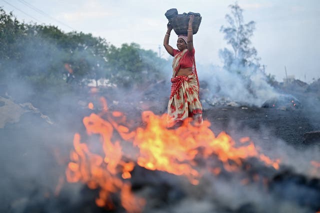 <p>A woman carries a basket of coal from a mine in Jharia on the outskirts of Dhanbad in India’s Jharkhand state </p>