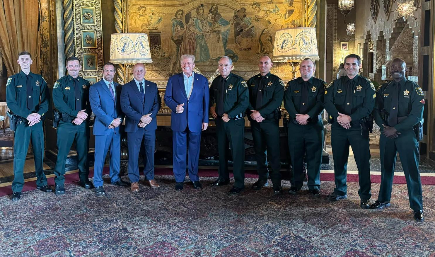 Trump (pictured) with Martin County Sheriff’s deputies on Tuesday