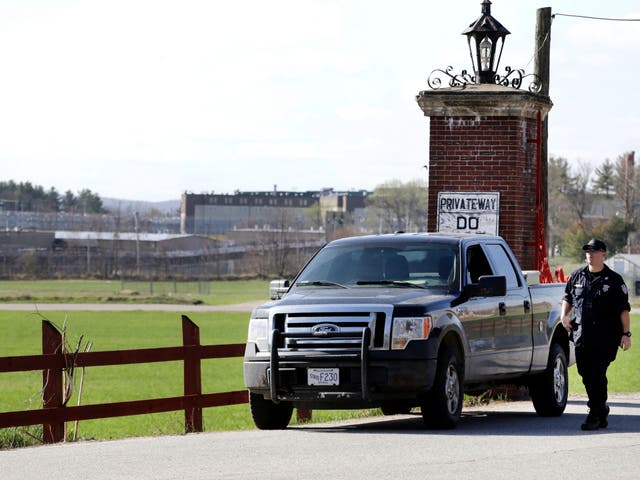 <p>A police officer guards an entrance to the Souza-Baranowski Correctional Center on April 19, 2017, in Shirley, Massachusetts. Five guards at the facility were injured on September 18 when a group of inmates assaulted them, stabbing two and assaulting three others</p>