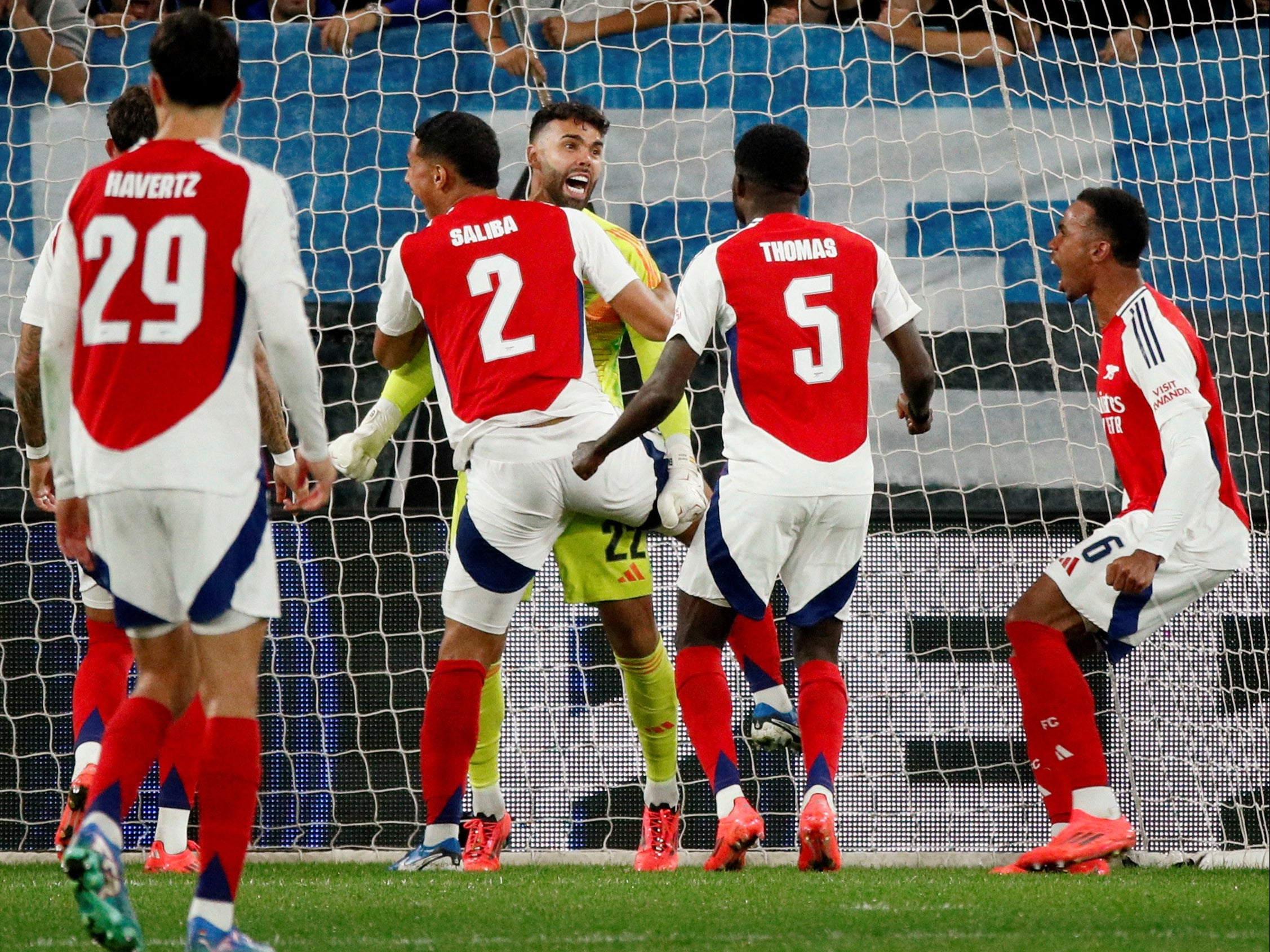 David Raya is surrounded by his team-mates after his double save