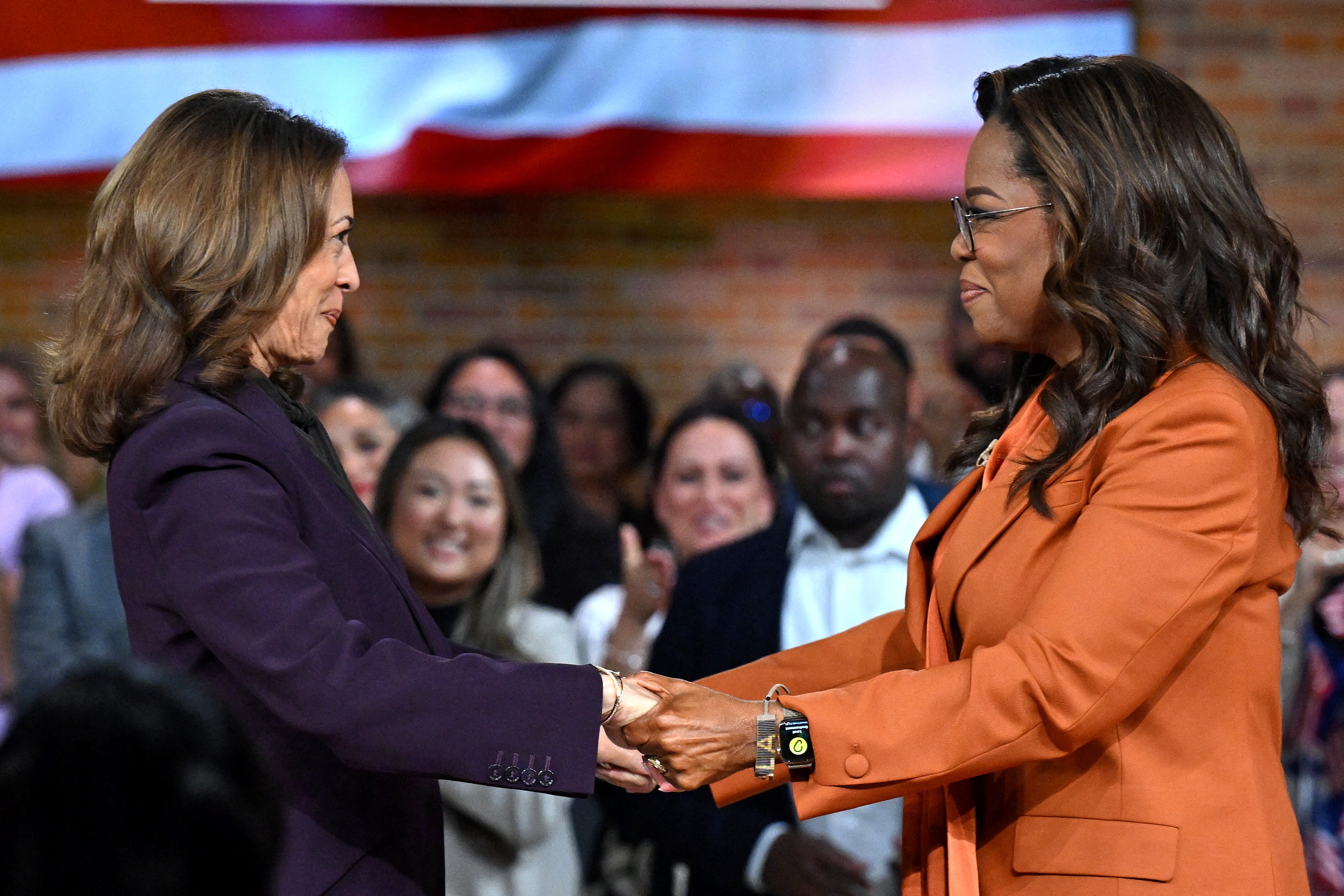 US Vice President and Democratic presidential candidate Kamala Harris (L) joins US television producer Oprah Winfrey at a 'Unite for America' live streaming rally in Farmington Hills, Michigan, on September 19, 2024