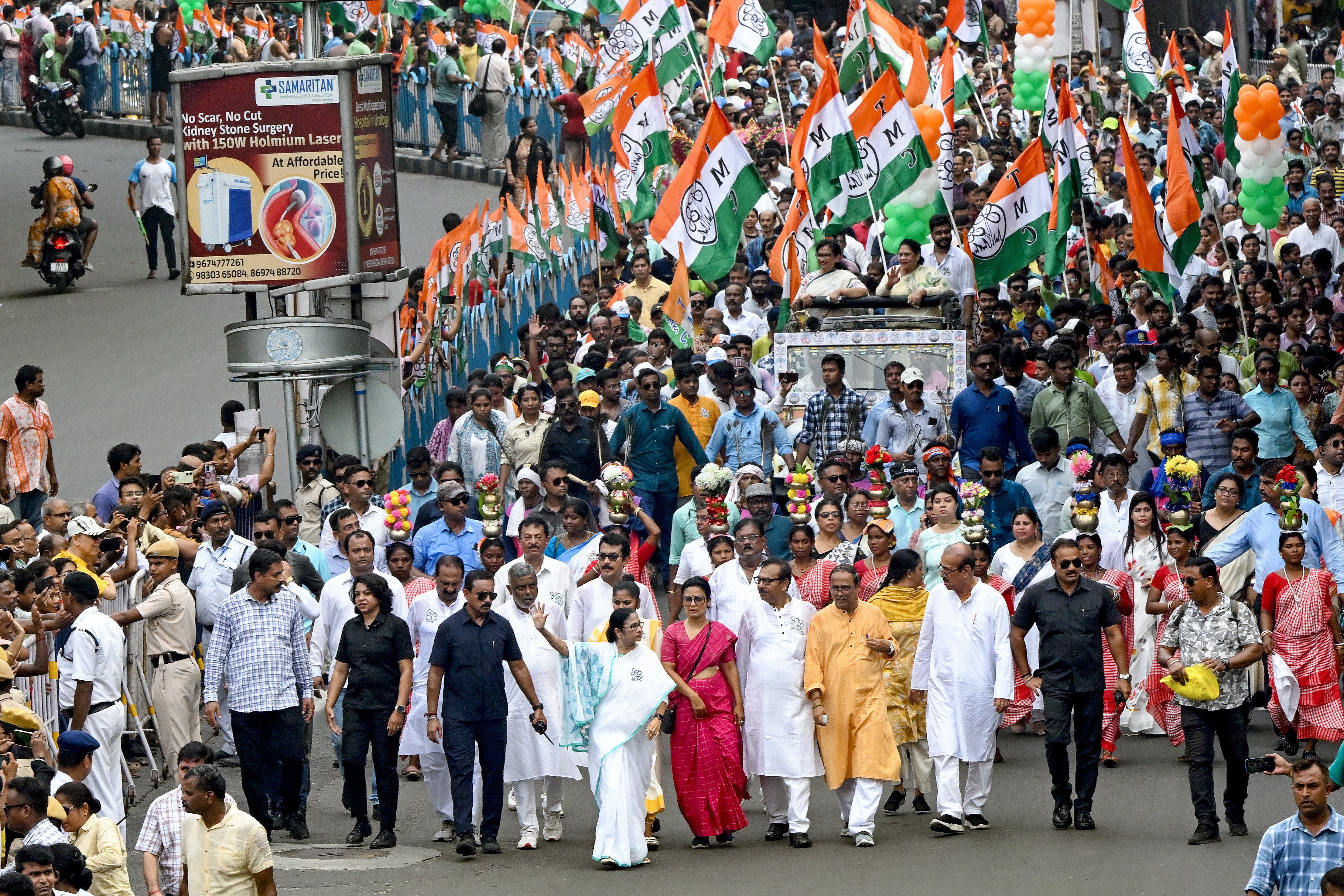 Mamata Banerjee (C, bottom), chief minister of India’s West Bengal state and leader of Trinamool Congress (TMC) party along with party leaders and workers take part in an election campaign rally in Kolkata on 30 May 2024