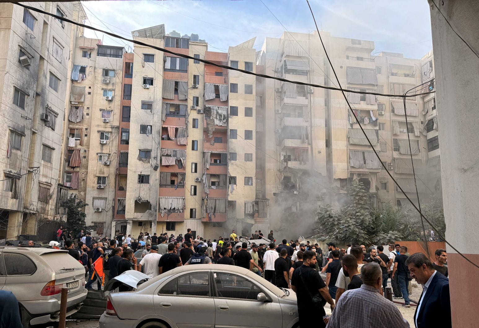 People inspect the site of an Israeli strike in the southern suburbs of Beirut, Lebanon