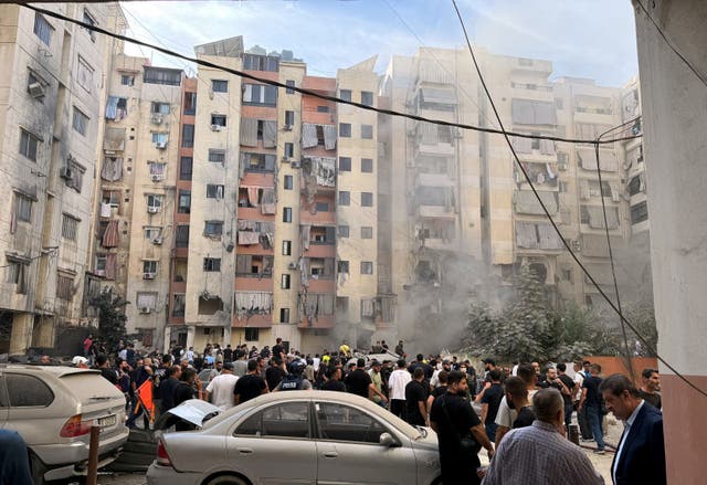 <p>People inspect the site of an Israeli strike in the southern suburbs of Beirut, Lebanon</p>