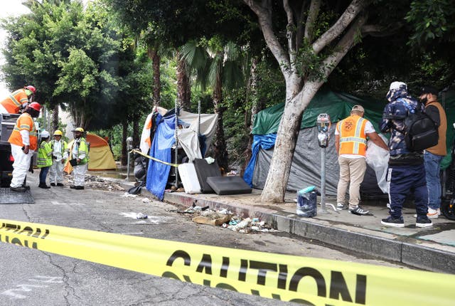 <p>Members of the Los Angeles’ Inside Safe team help an unhoused person  make their way from an encampment to a bus to be brought to interim housing, as part of an ‘Inside Safe’ operation in September. The US is on pace for its highest homeless population count ever.  </p>