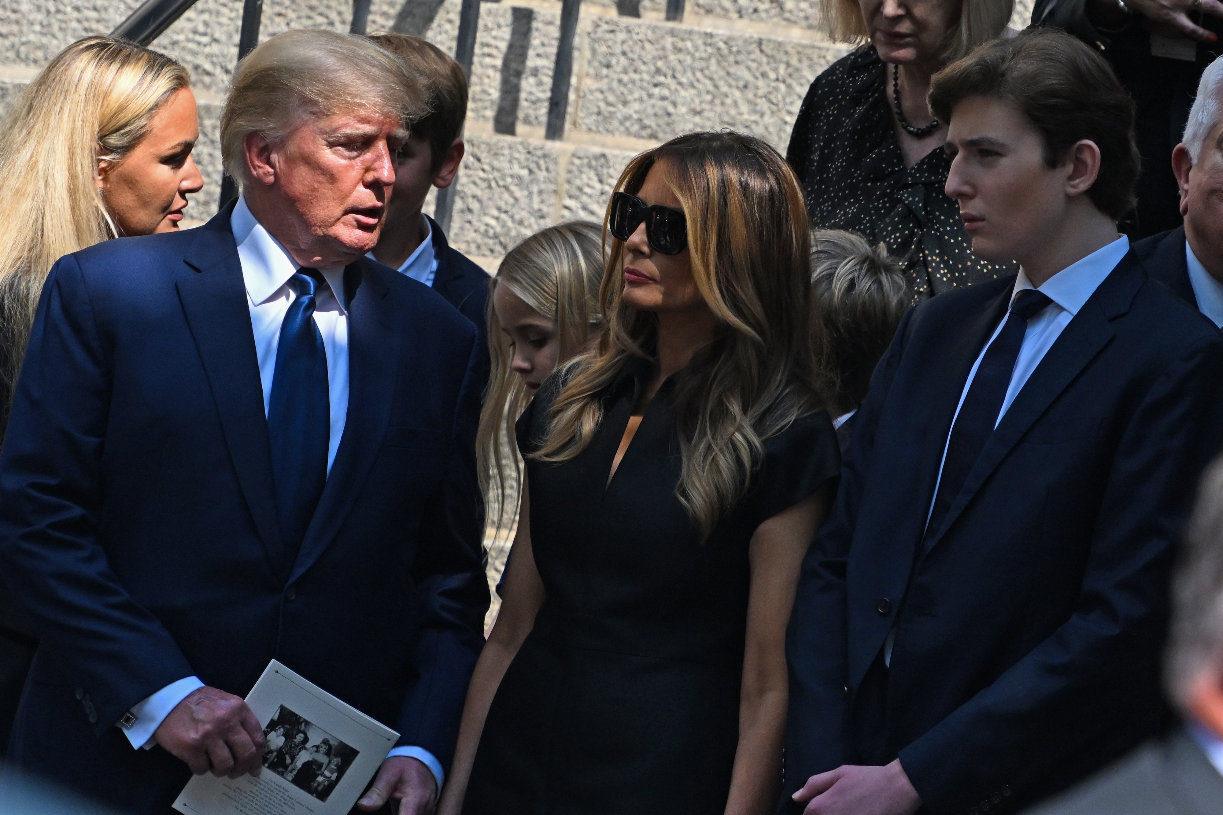 Former President Donald J. Trump, Melania Trump and Barron Trump exit the funeral of Ivana Trump at St. Vincent Ferrer Roman Catholic Church July 20, 2022 in New York City