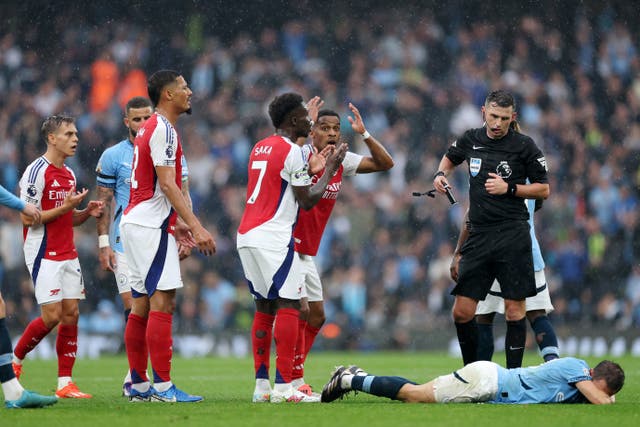 <p>Leandro Trossard, left, protests with his Arsenal teammates</p>