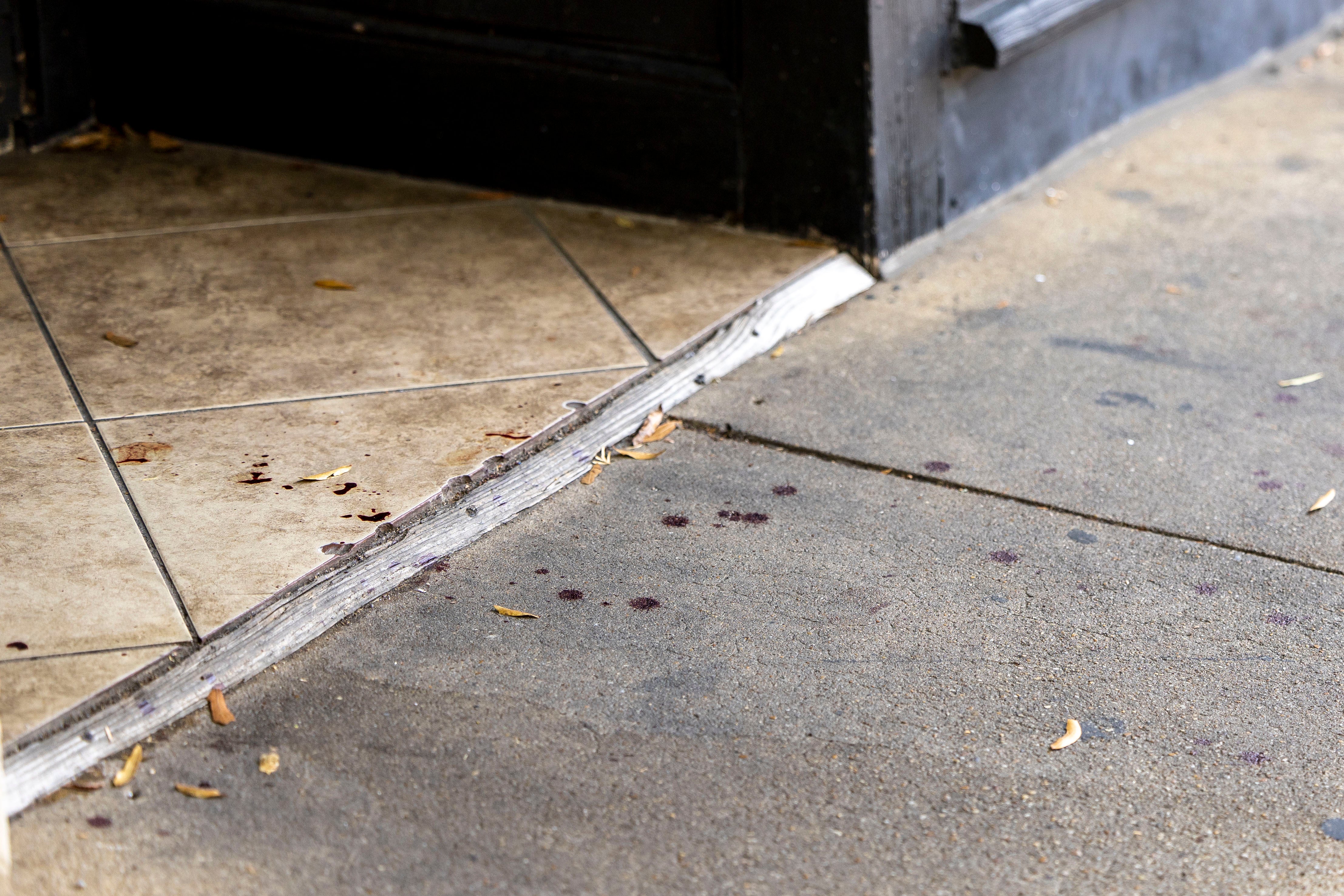 Drops of blood on the sidewalk in the Five Points South neighborhood following Saturday’s shooting. Police say the gunmen may have used ‘switches’ to allow their firearms to function as machine guns