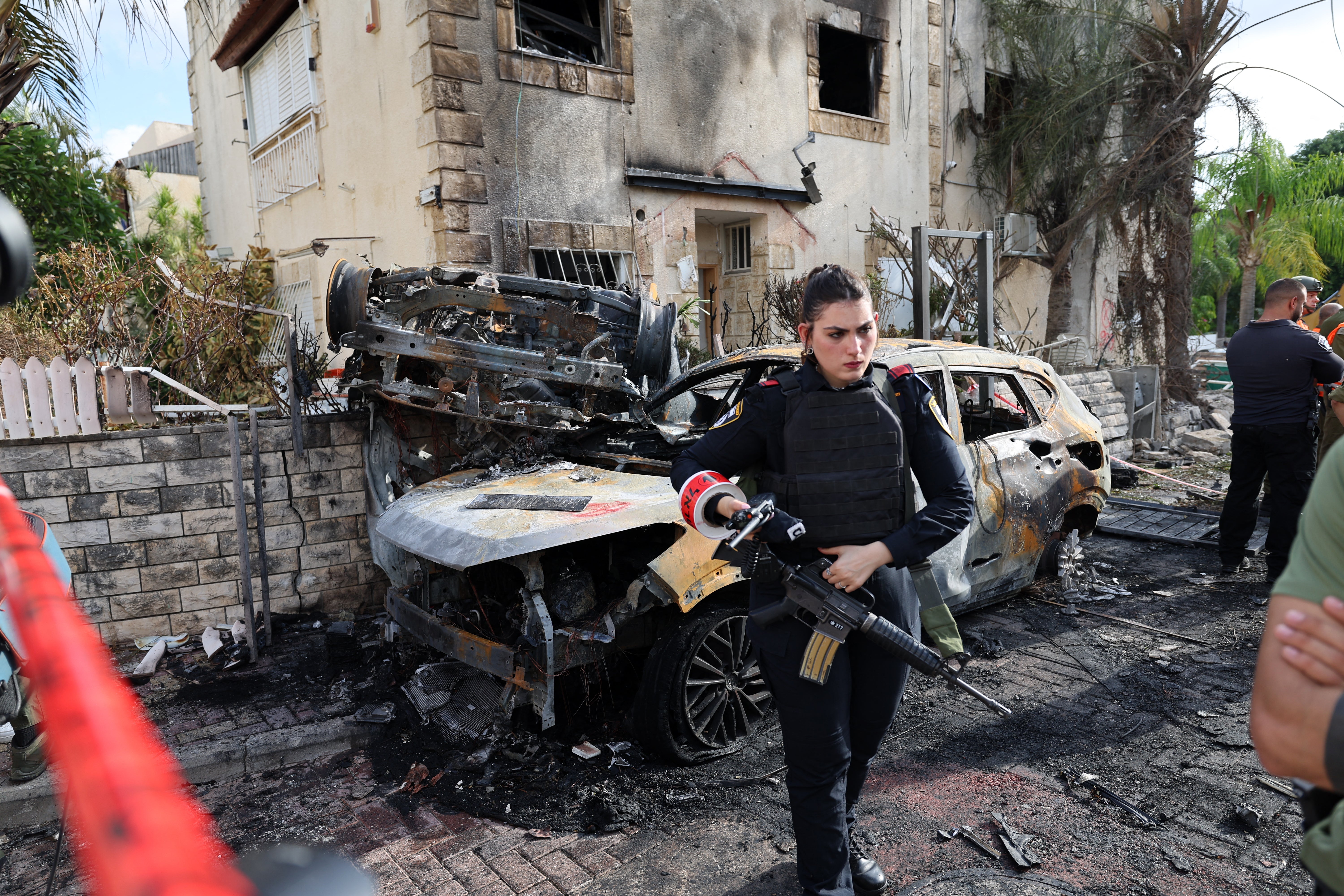 A member of the Israeli security forces stands guard inside a cordoned-off area in Kiryat Bialik in the Haifa district of Israel, targeted by a reported strike by Lebanon’s Hezbollah on 22 September 2024