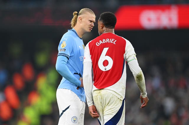 <p>Gabriel clashes with Erling Haaland at the Etihad Stadium</p>