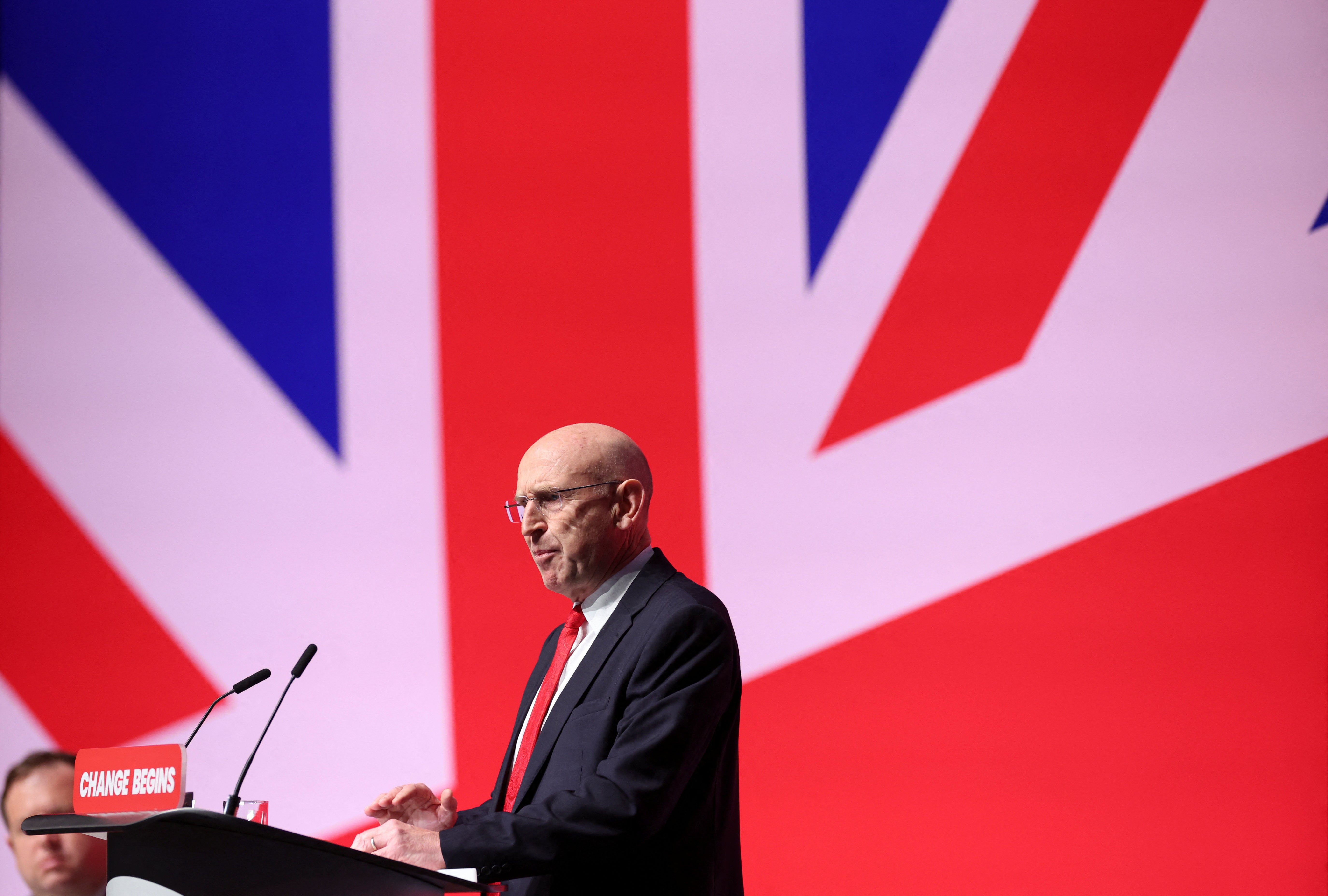 Defence Secretary John Healey speaks on stage at Britain's Labour Party's annual conference in Liverpool