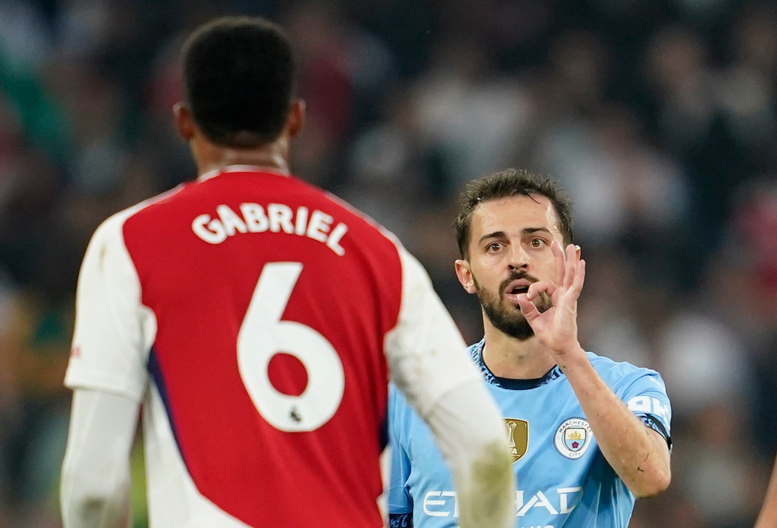 Manchester City's Bernardo Silva gestures at Arsenal's Gabriel