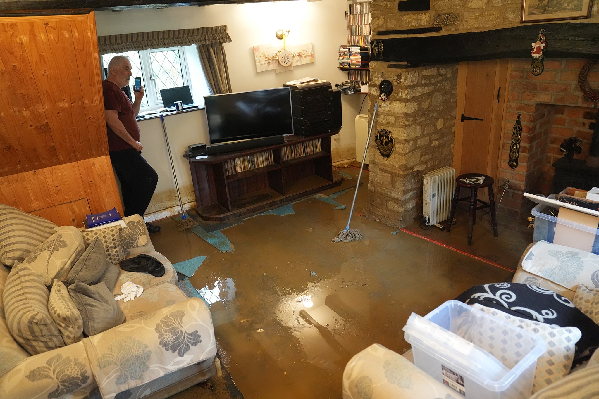 Tim Maher in his flooded house in Grendon, Northamptonshire