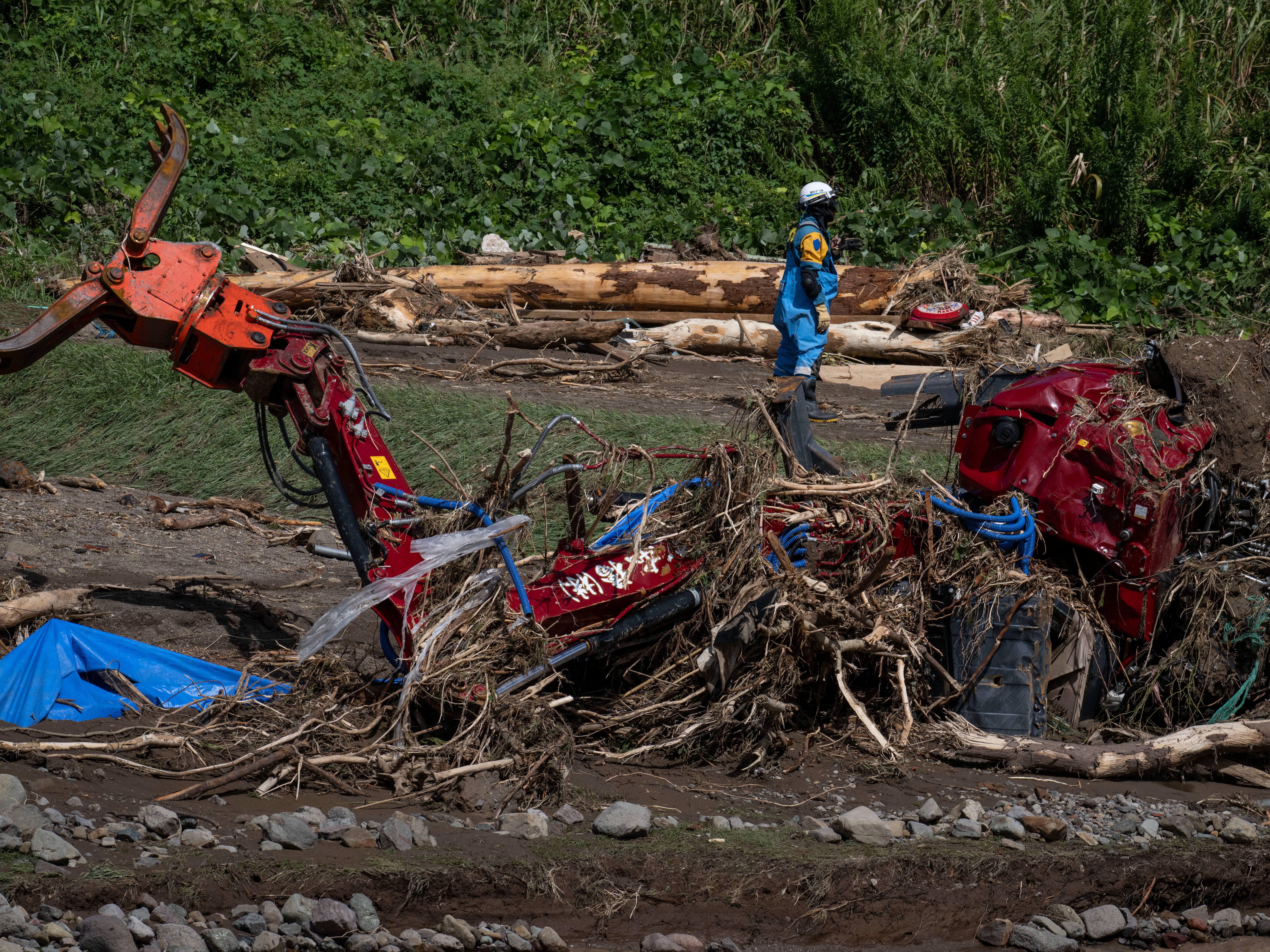 Mangled heavy machinery washed away from flooding along the Tsukada River