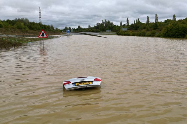 <p>A submerged car in flooding in Bedfordshire on Monday  </p>